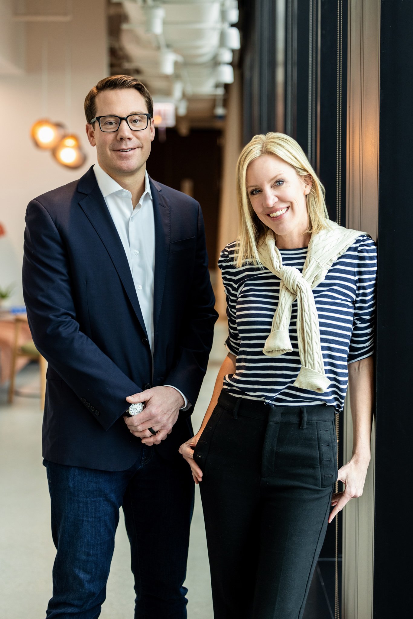 Corporate headshots of two team members together at their office.