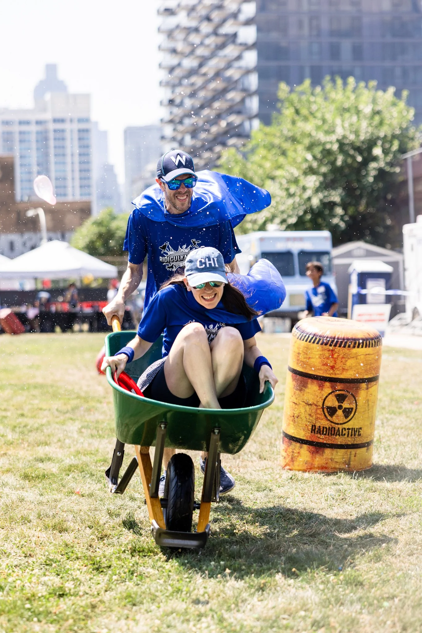 Team-building event of racing wheelbarrows at corporate retreat