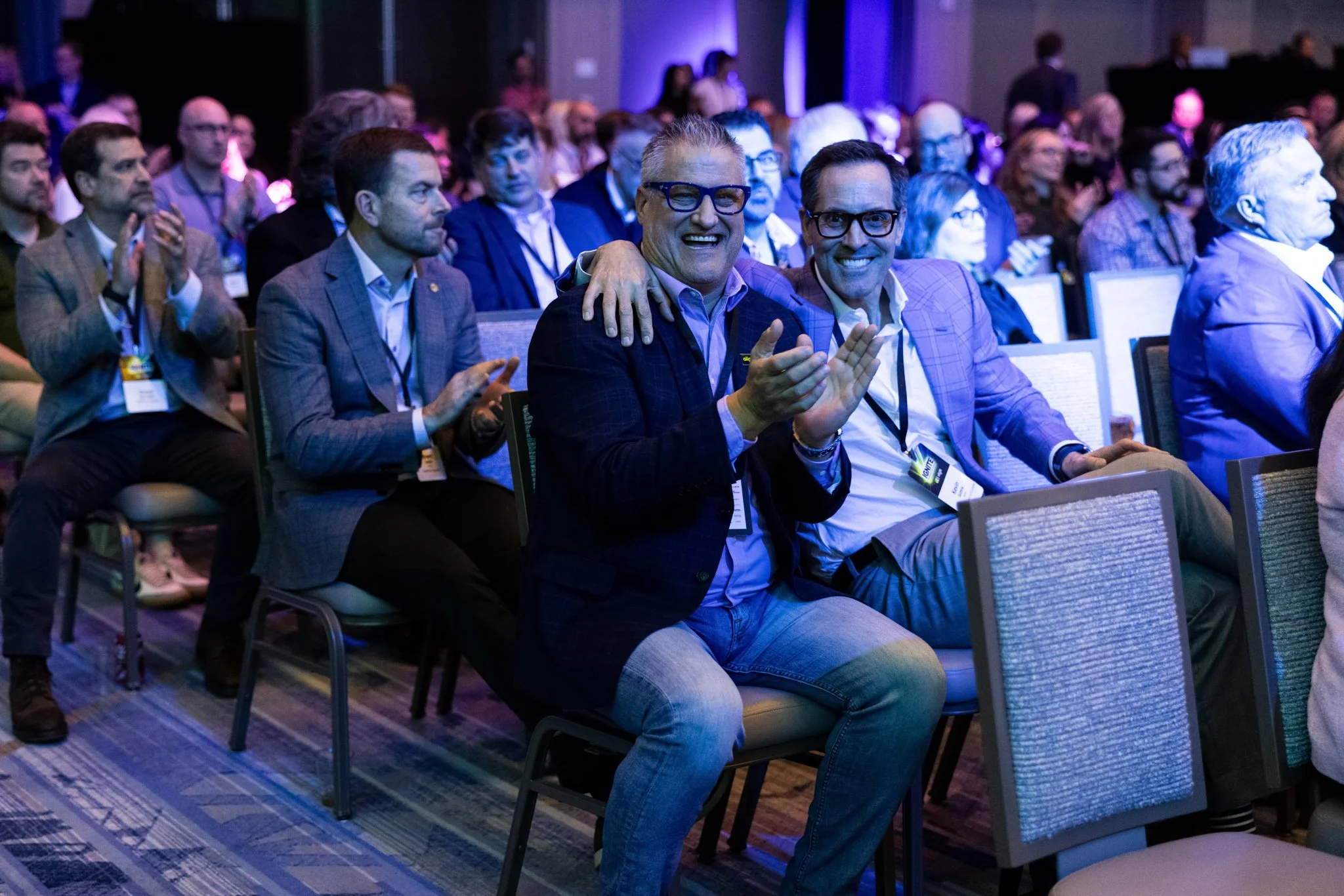 Attendees washed in blue light during corporate seminar in Chicago