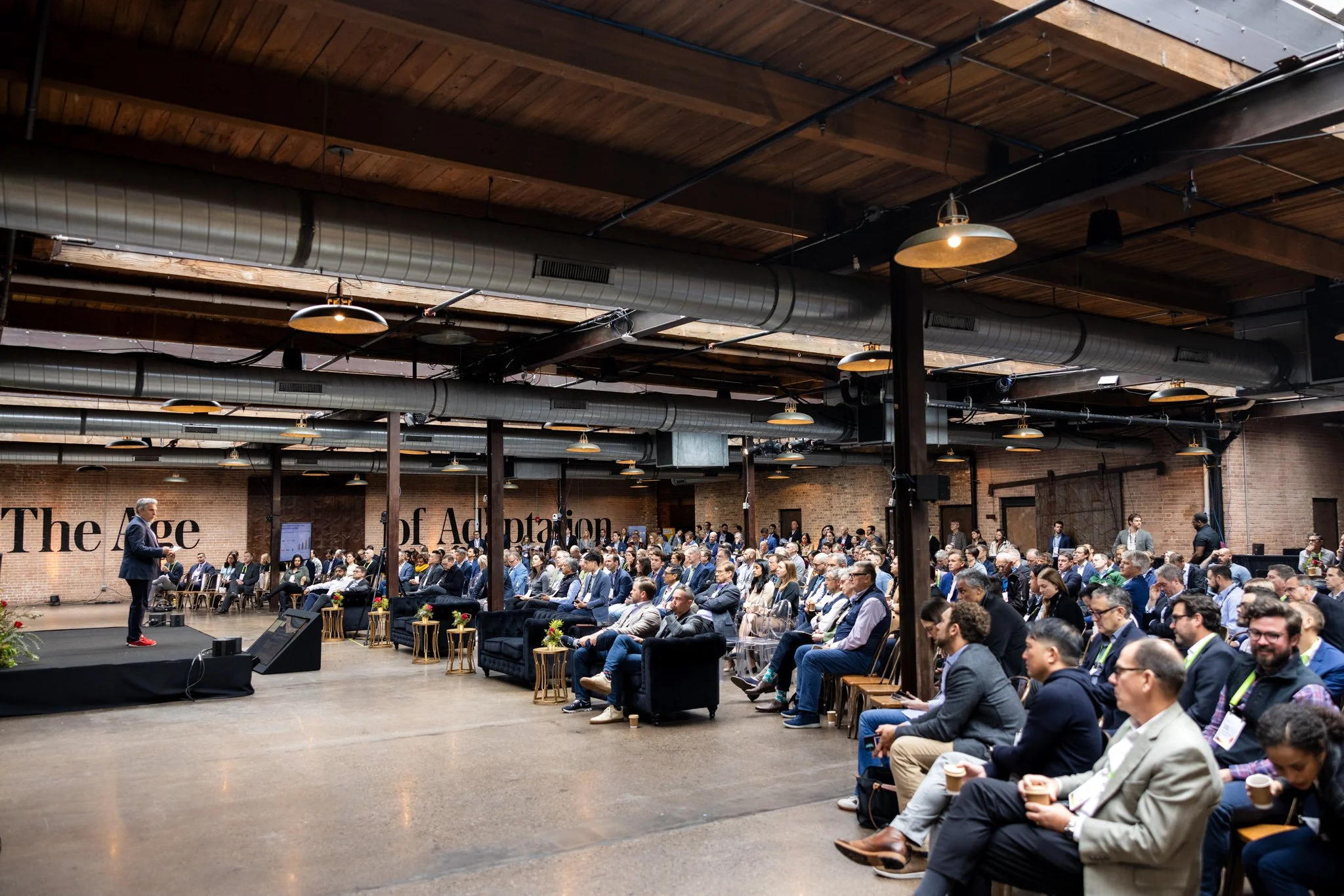 Large corporate seminar in Chicago, occuring in an old warehouse