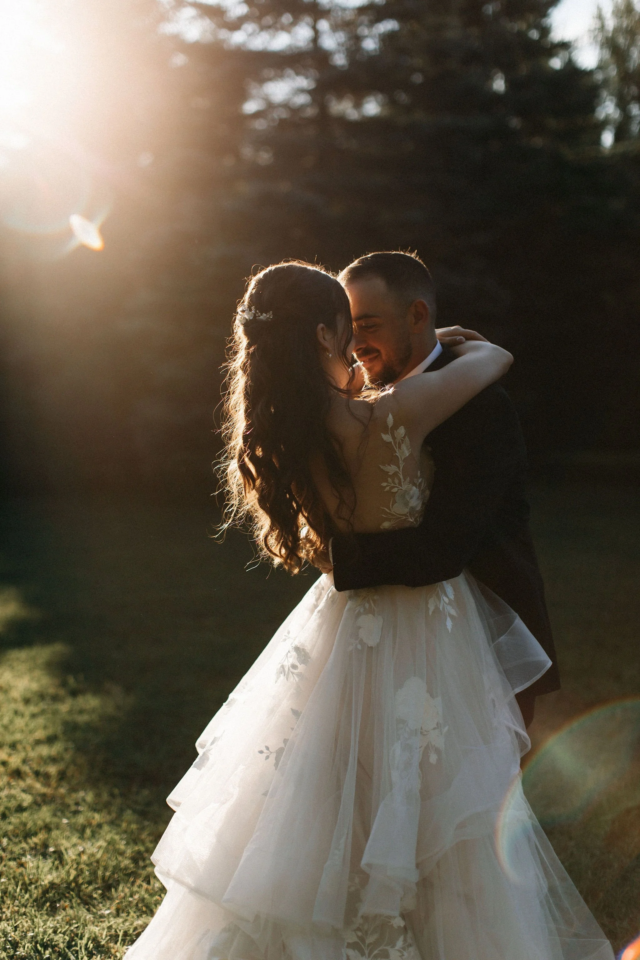 Bride and groom embracing during golden hour outdoor wedding portrait with inTUNE Stratford wedding DJs
