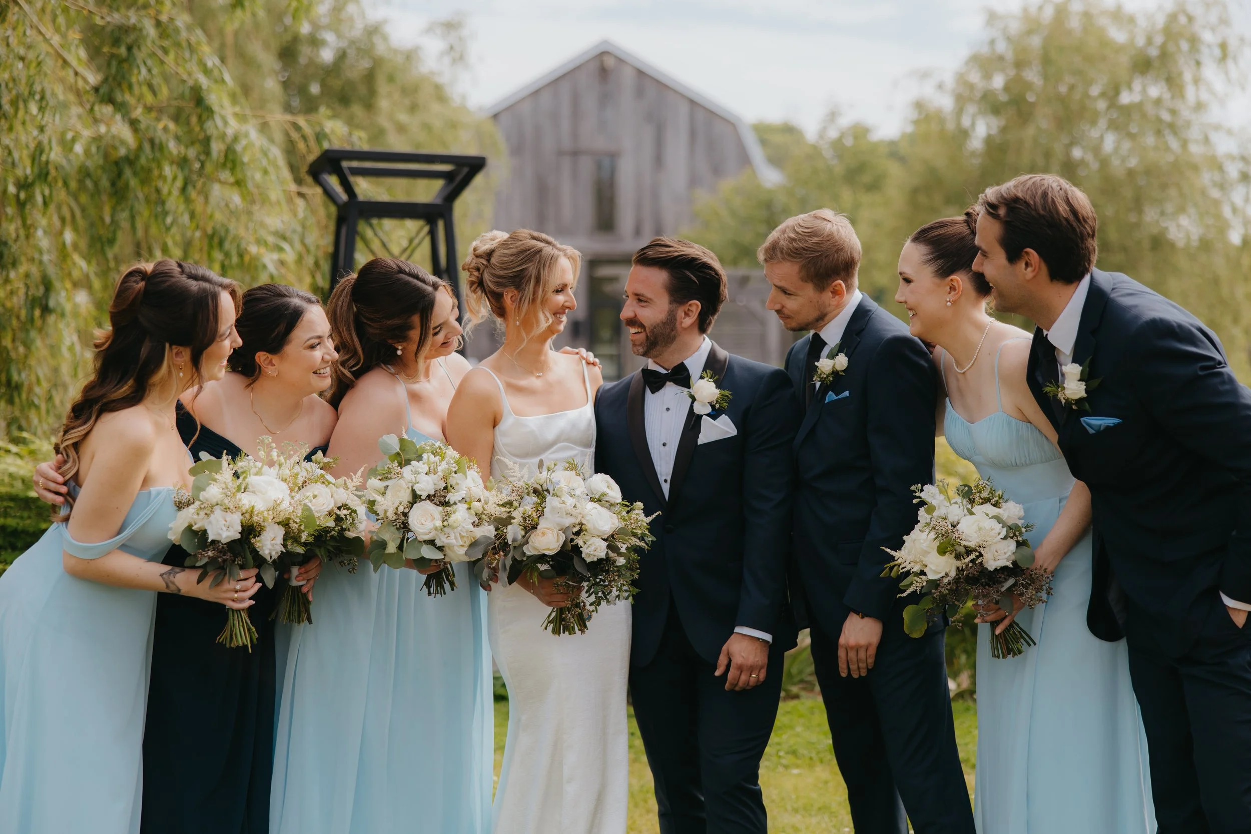 bride and groom posing with bridal party