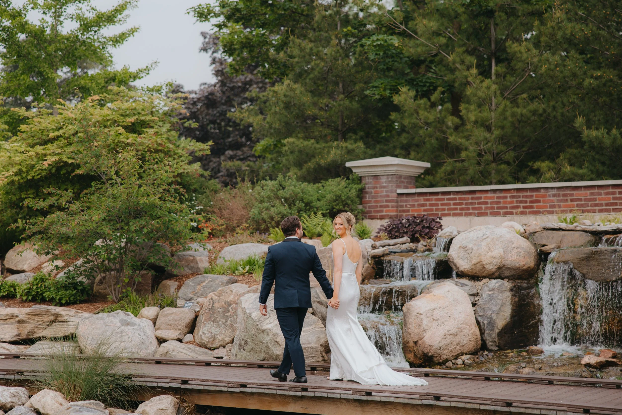 bride and groom walking in a scenic setting