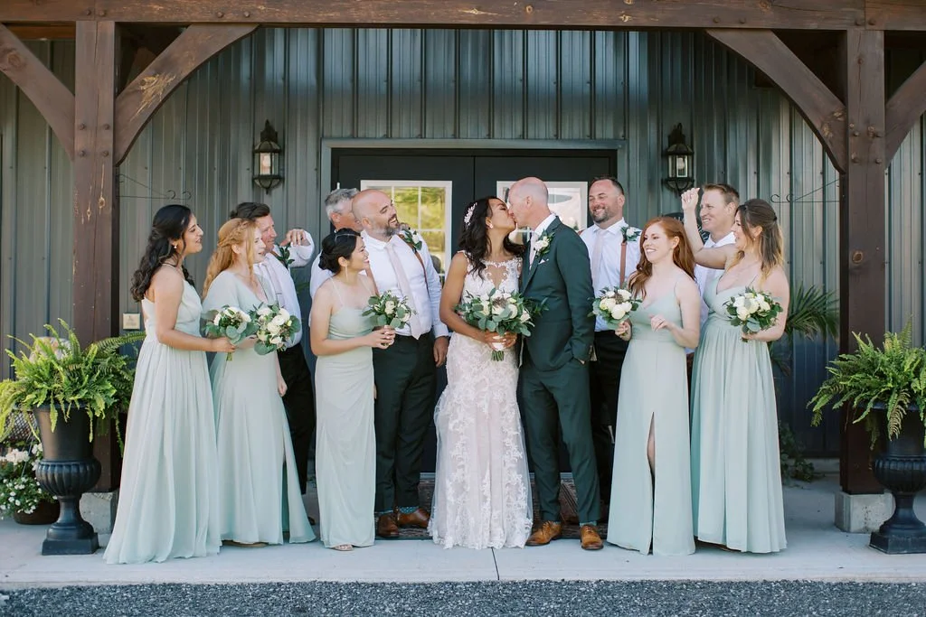 wedding couple kissing outside of barn swallow fields wedding venue