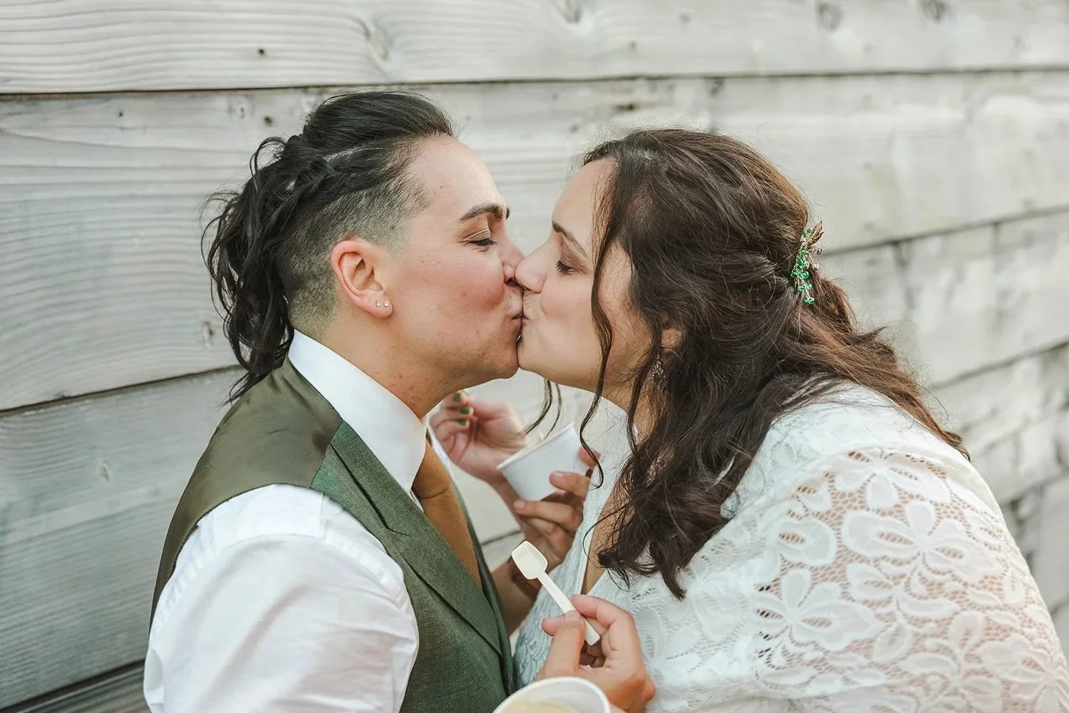 lgtbq couple kissing in wedding photo holding ice cream with intune wedding djs