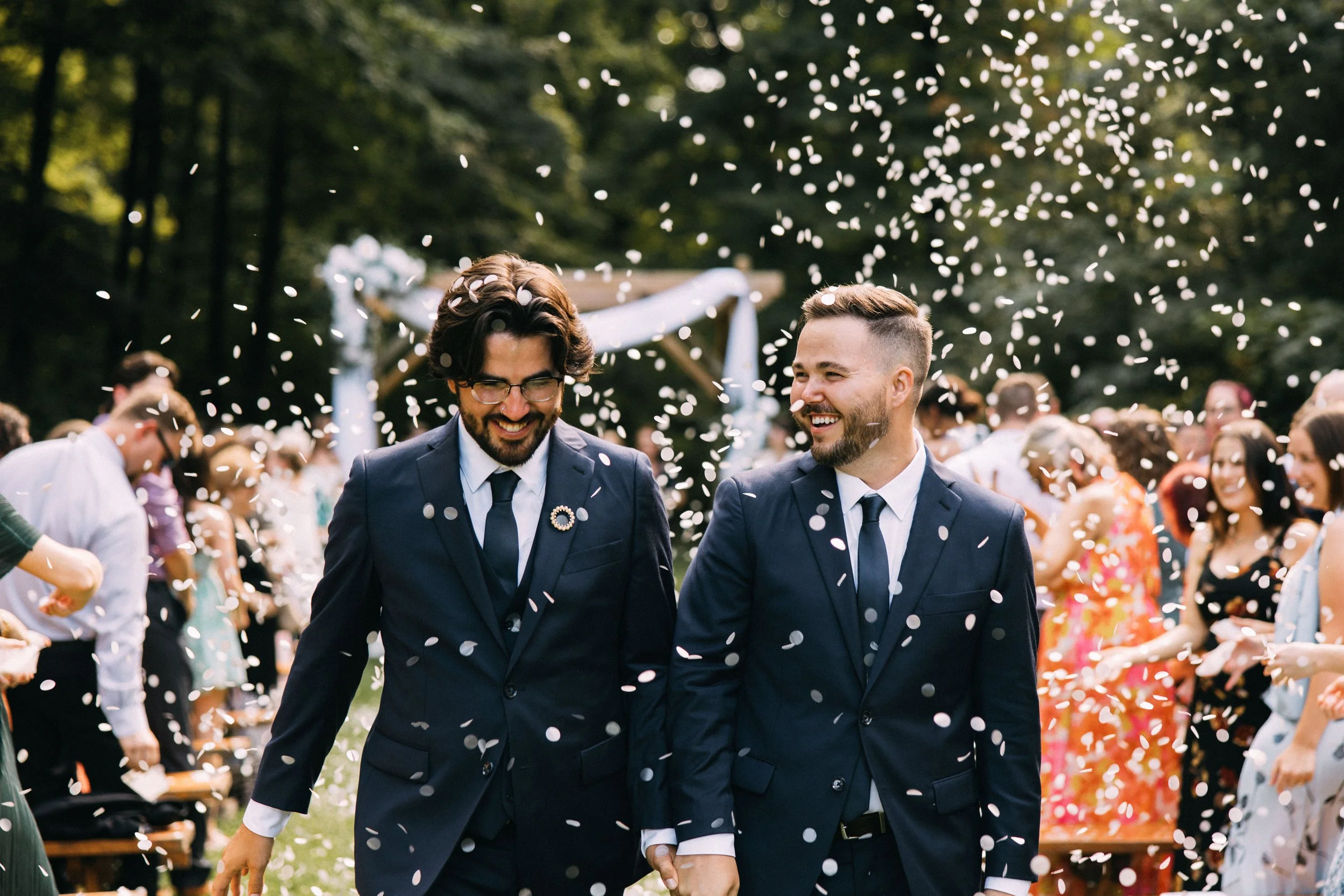 lgtbq couple in navy suits just married with intune wedding djs