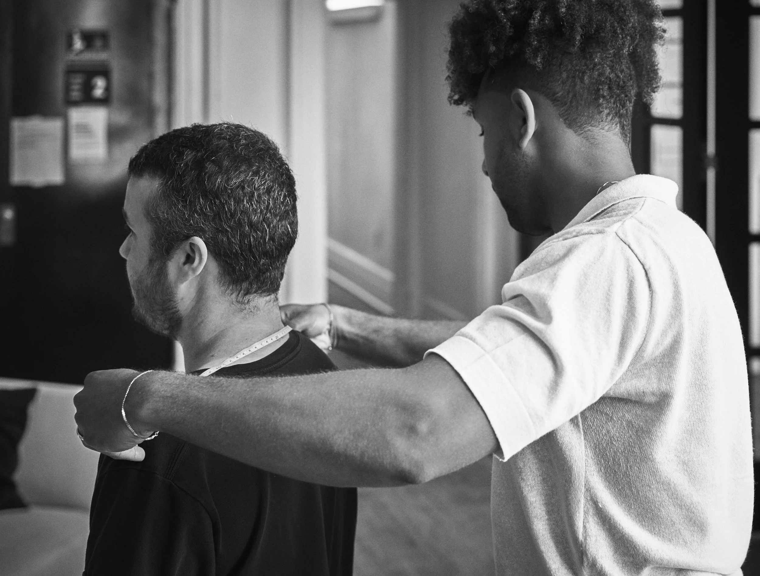 A barber giving a haircut to a customer in a barbershop.