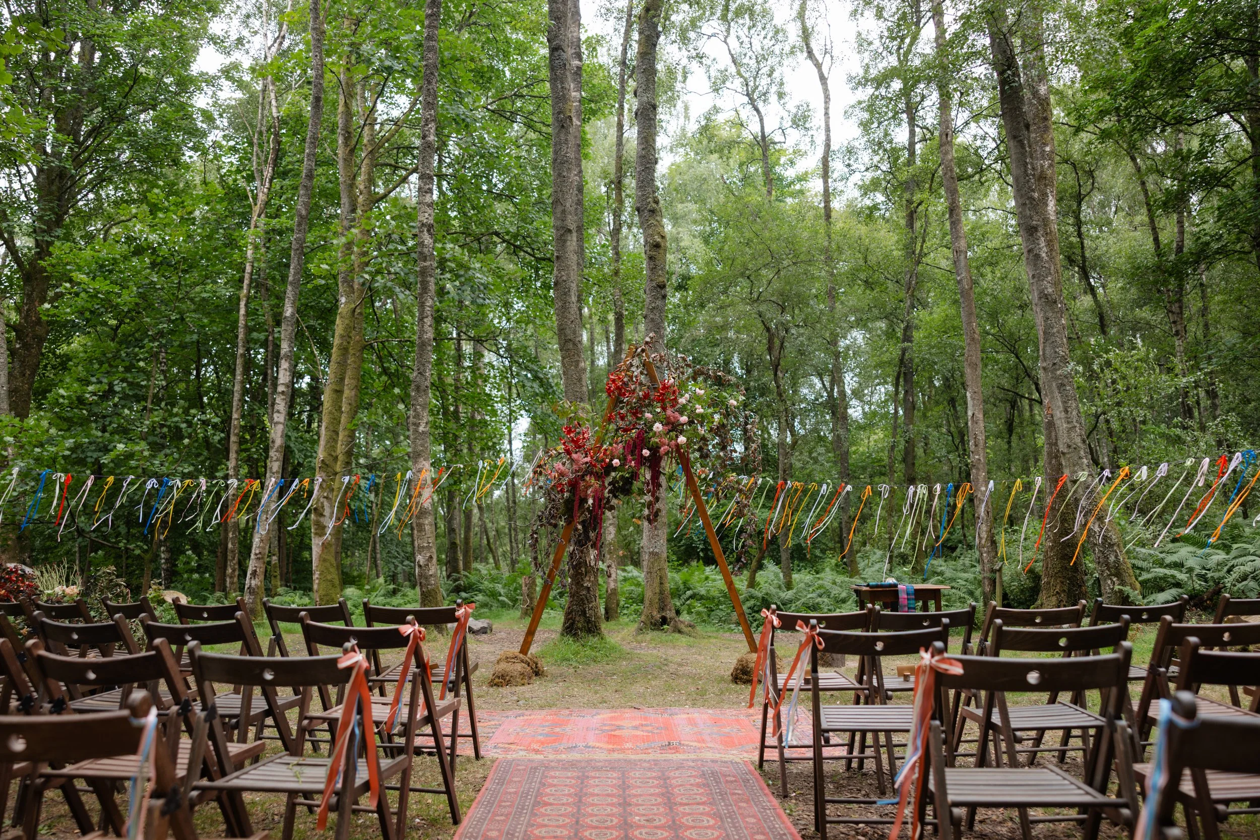 woodland ceremony at Comrie Croft Perthshire with floral arch