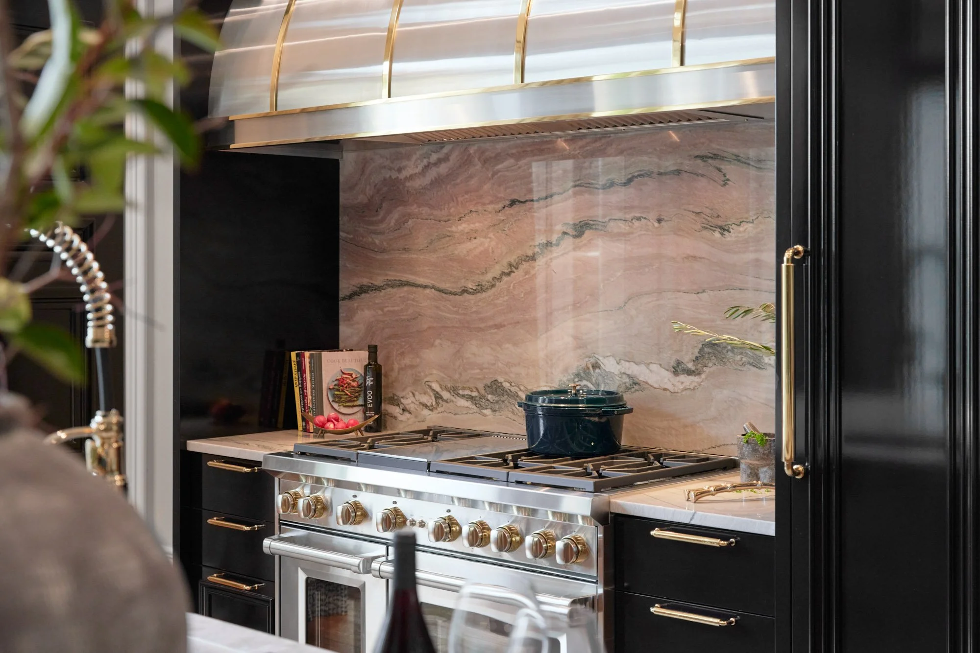  Kitchen stove with marble backsplash and decor items. 