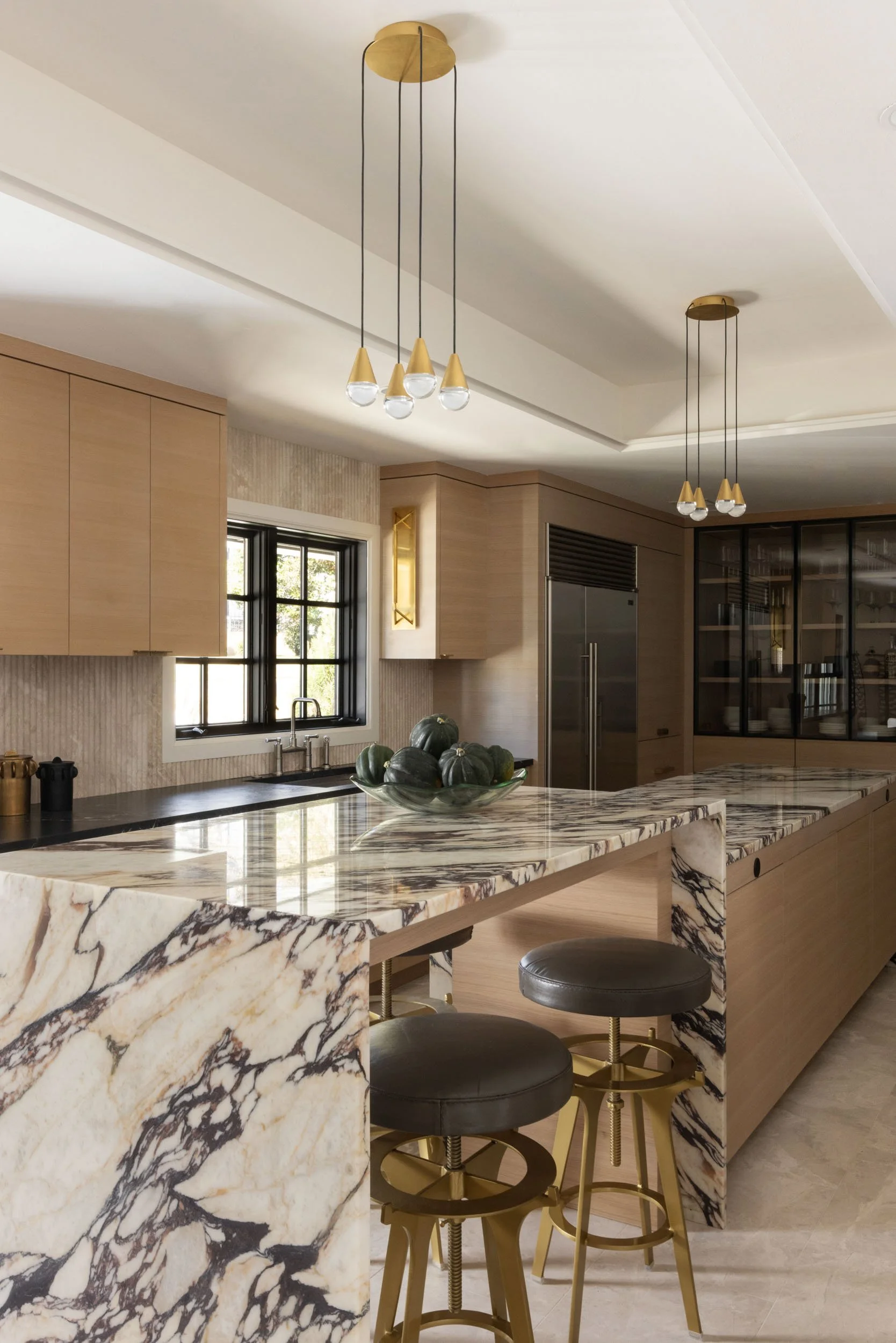  Kitchen countertops with light wood cabinets and other decor items.  