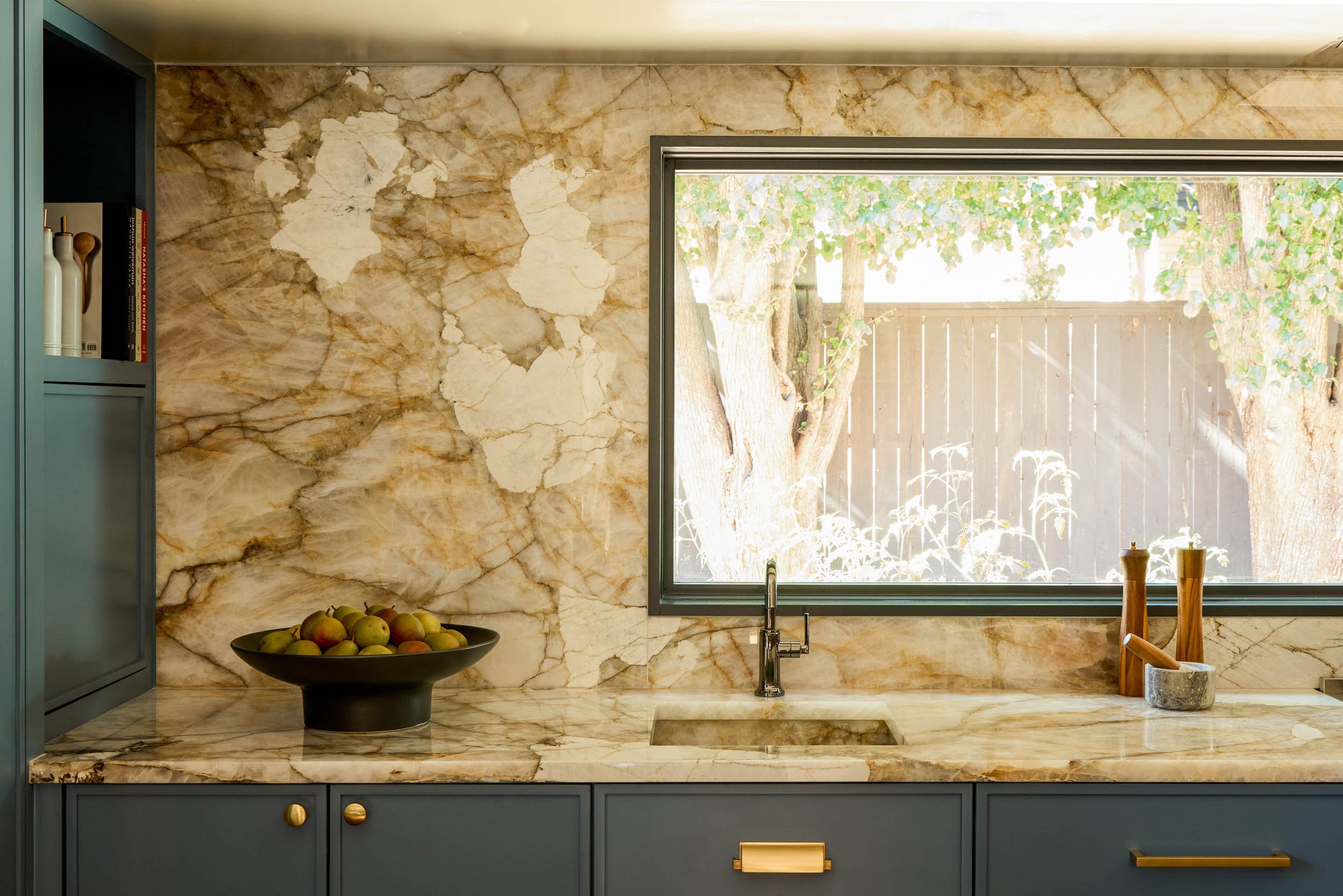  Kitchen countertops with matching wall, blue cabinets and other decor items.  