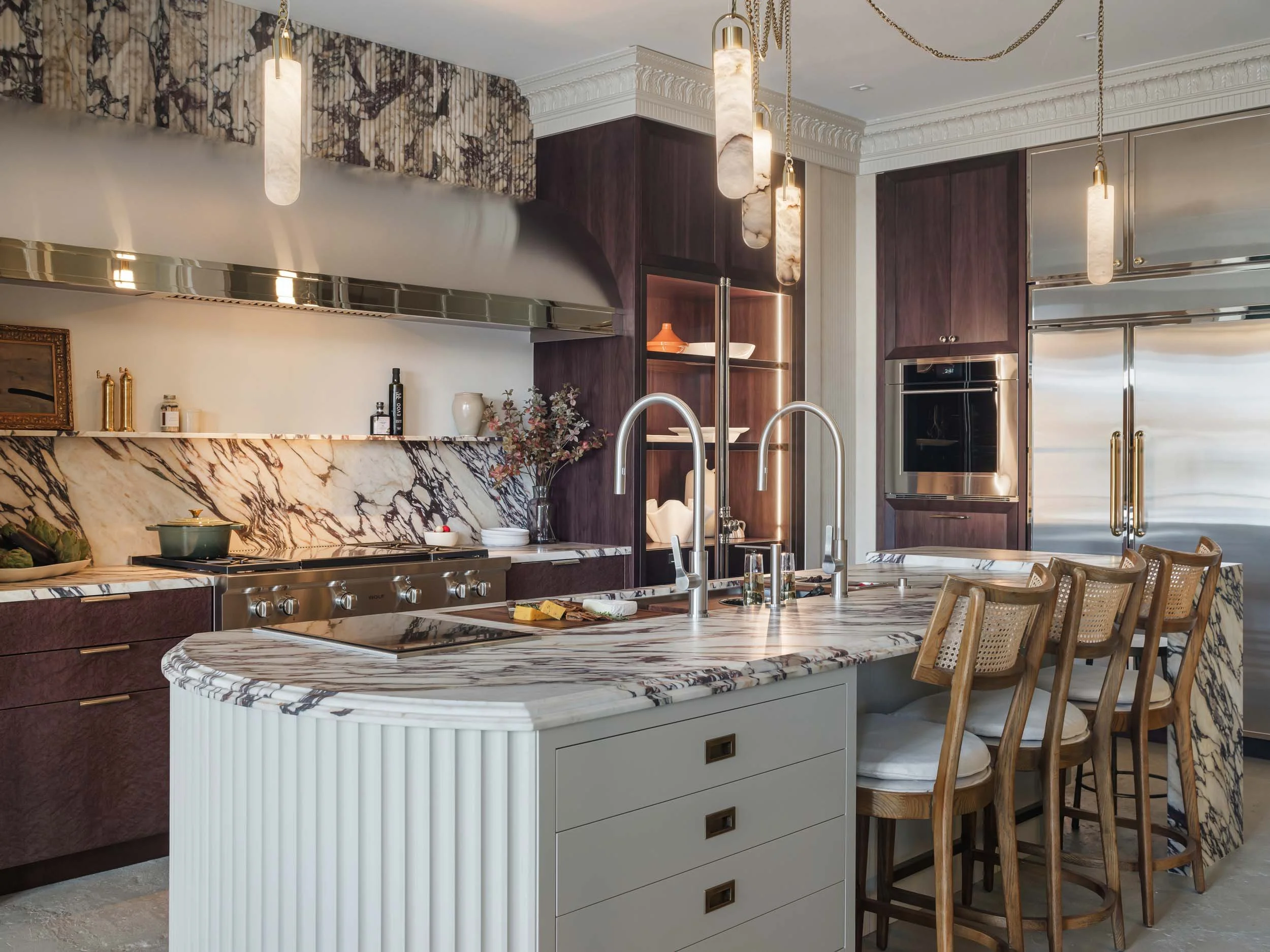 Marble countertops with matching backsplash, purple cabinets and other decor items.  