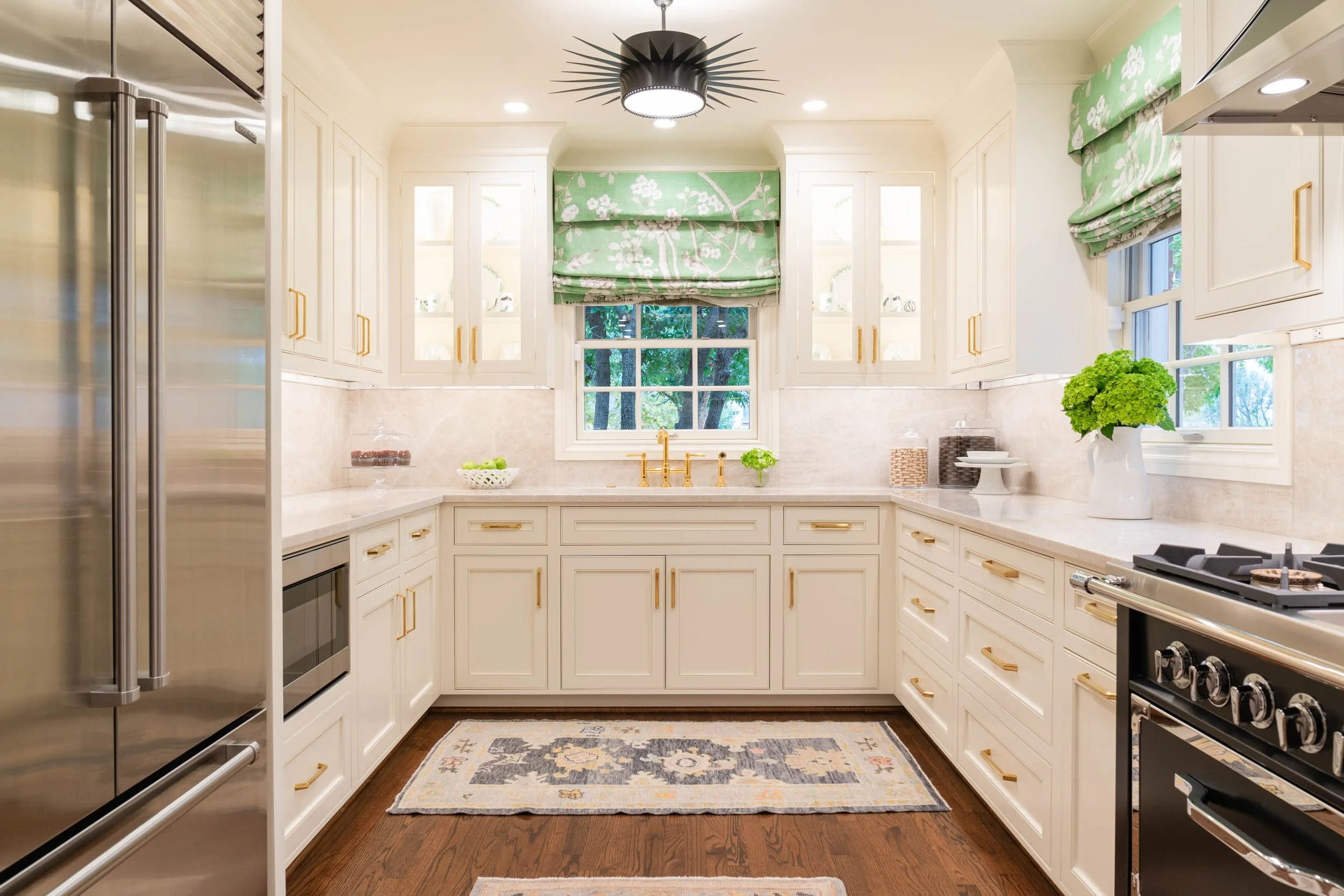  Marble countertops with white cabinets and gold accents.  