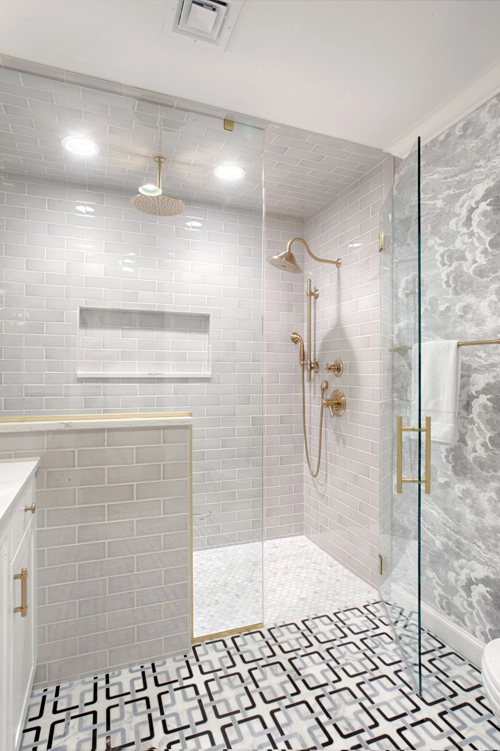  Custom tile for shower walls and floor with gold accents. 