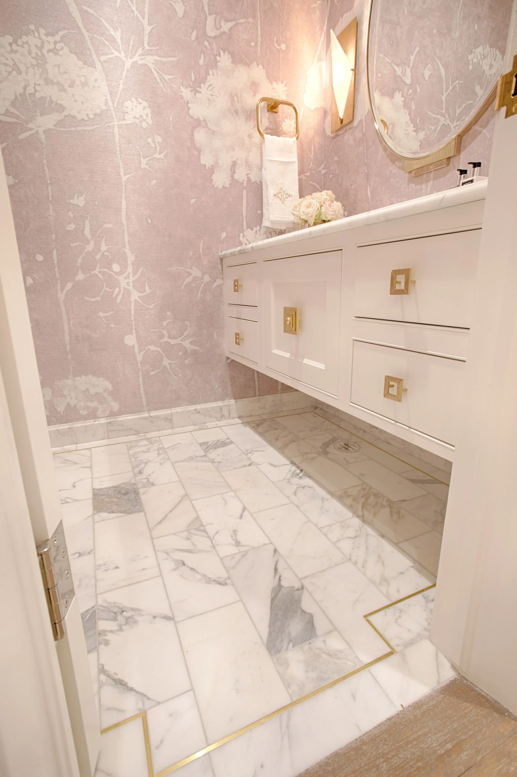  Custom tile with brass inlay and pink floral wallpaper.  