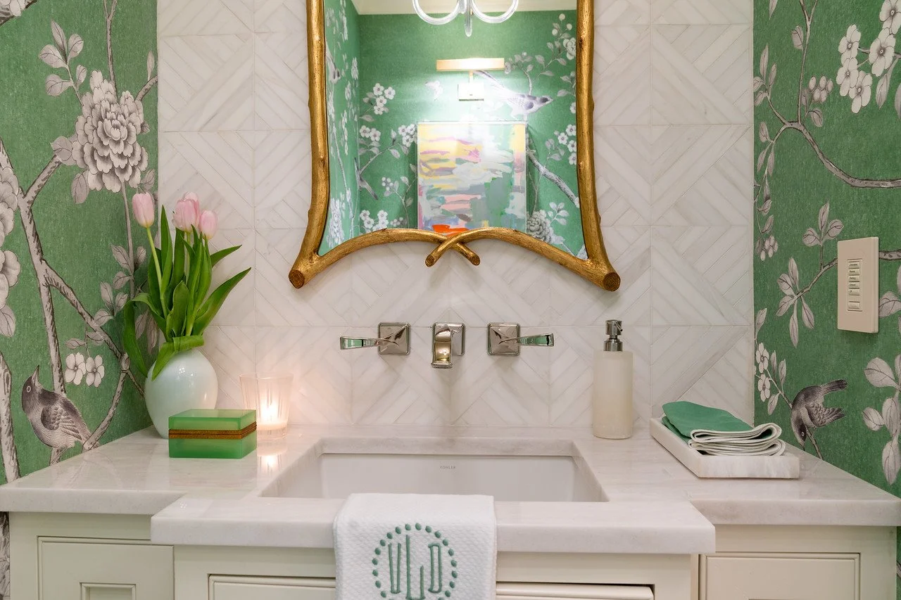  Powder bathroom with green wallpaper, custom tile, and marble countertops.  