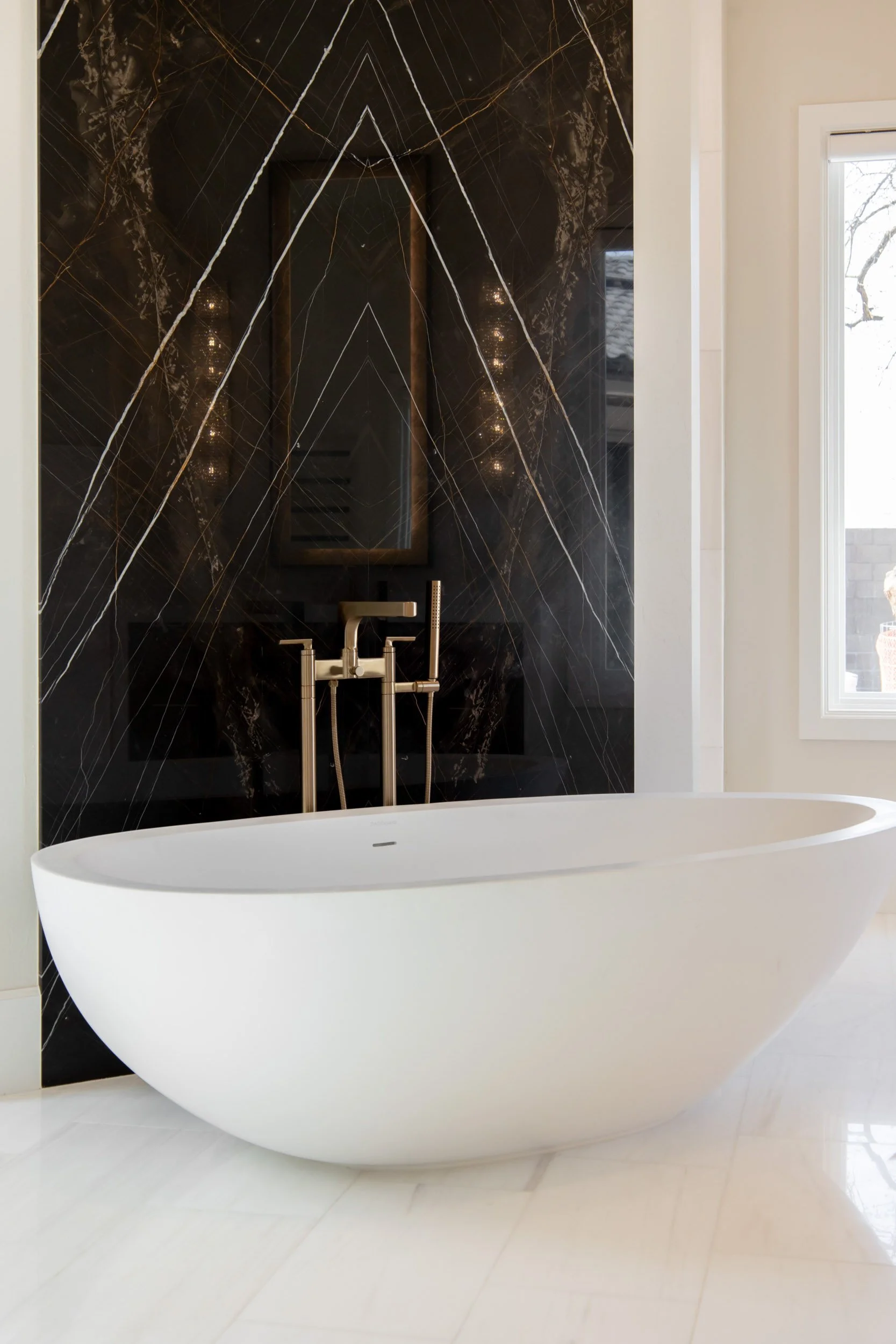  Bookmatched marble shower wall and white bathtub.  