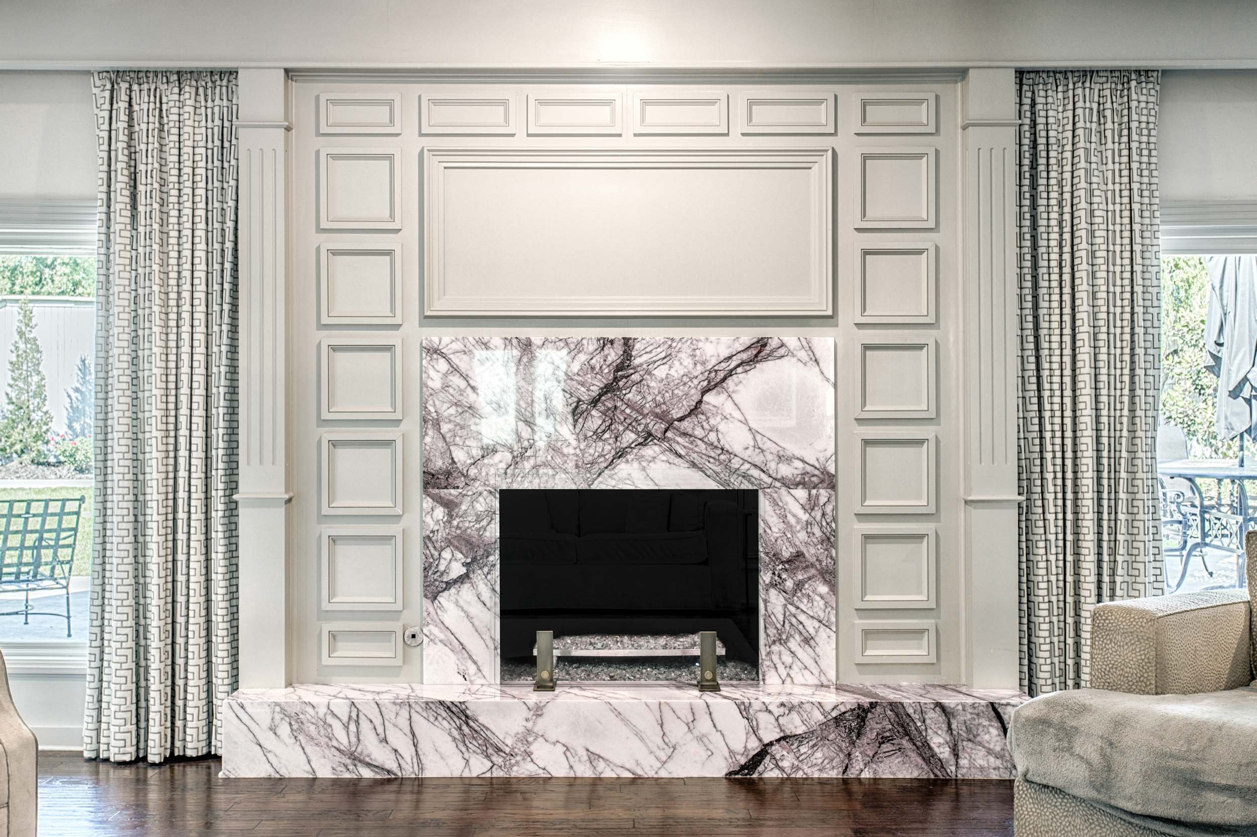  Lilac marble fireplace with sage green walls and curtains.  