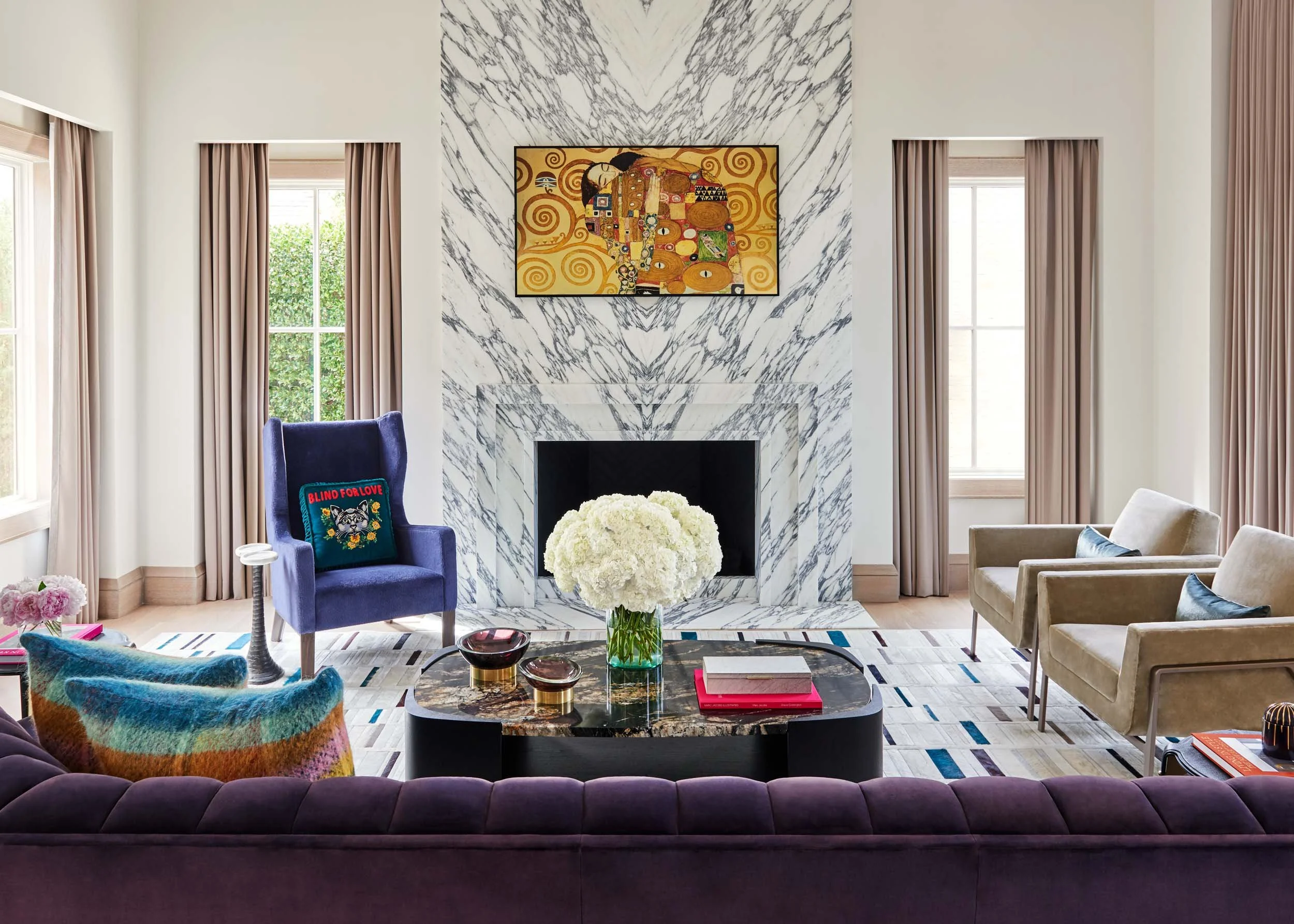  Bookmatched marble fireplace in a furnished living room.  