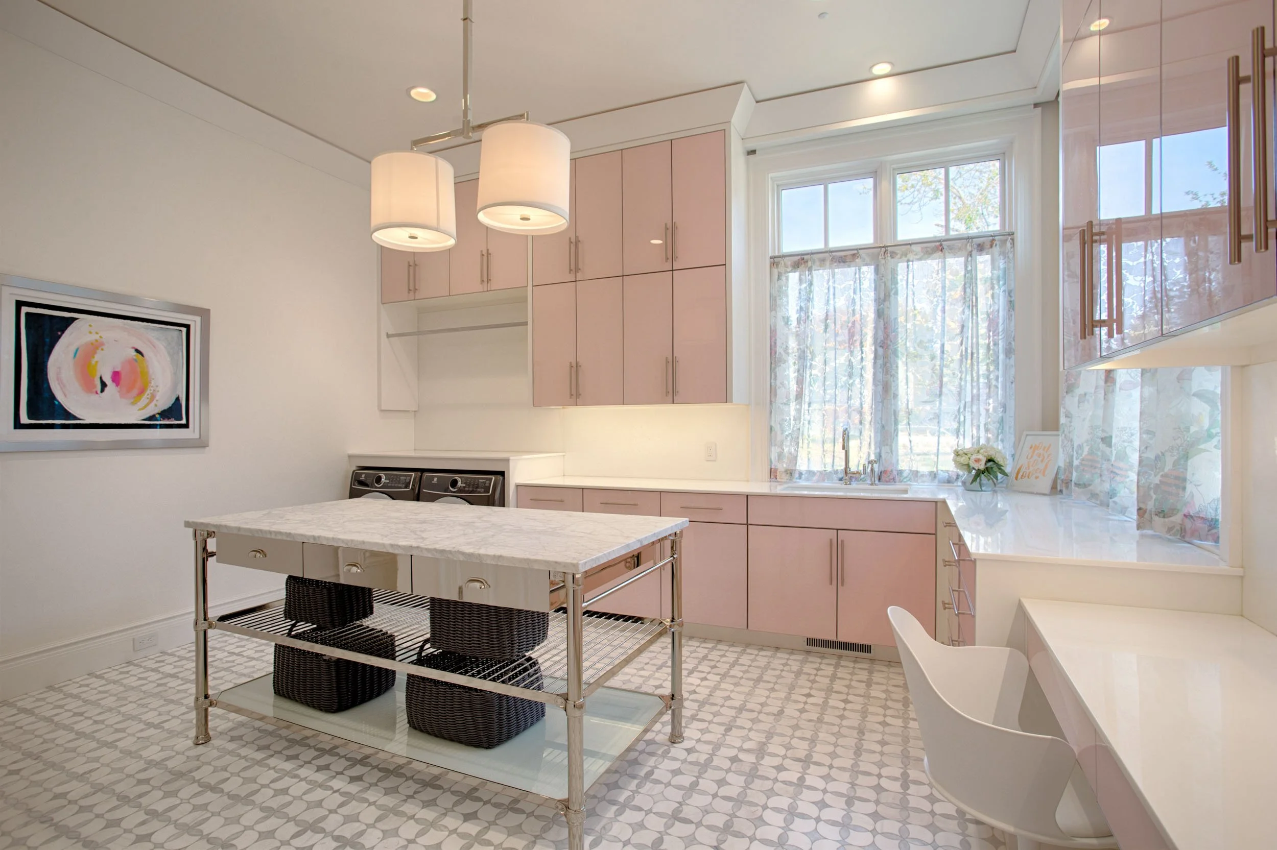  Laundry room with pink cabinets, custom tile floor and other decor items. 