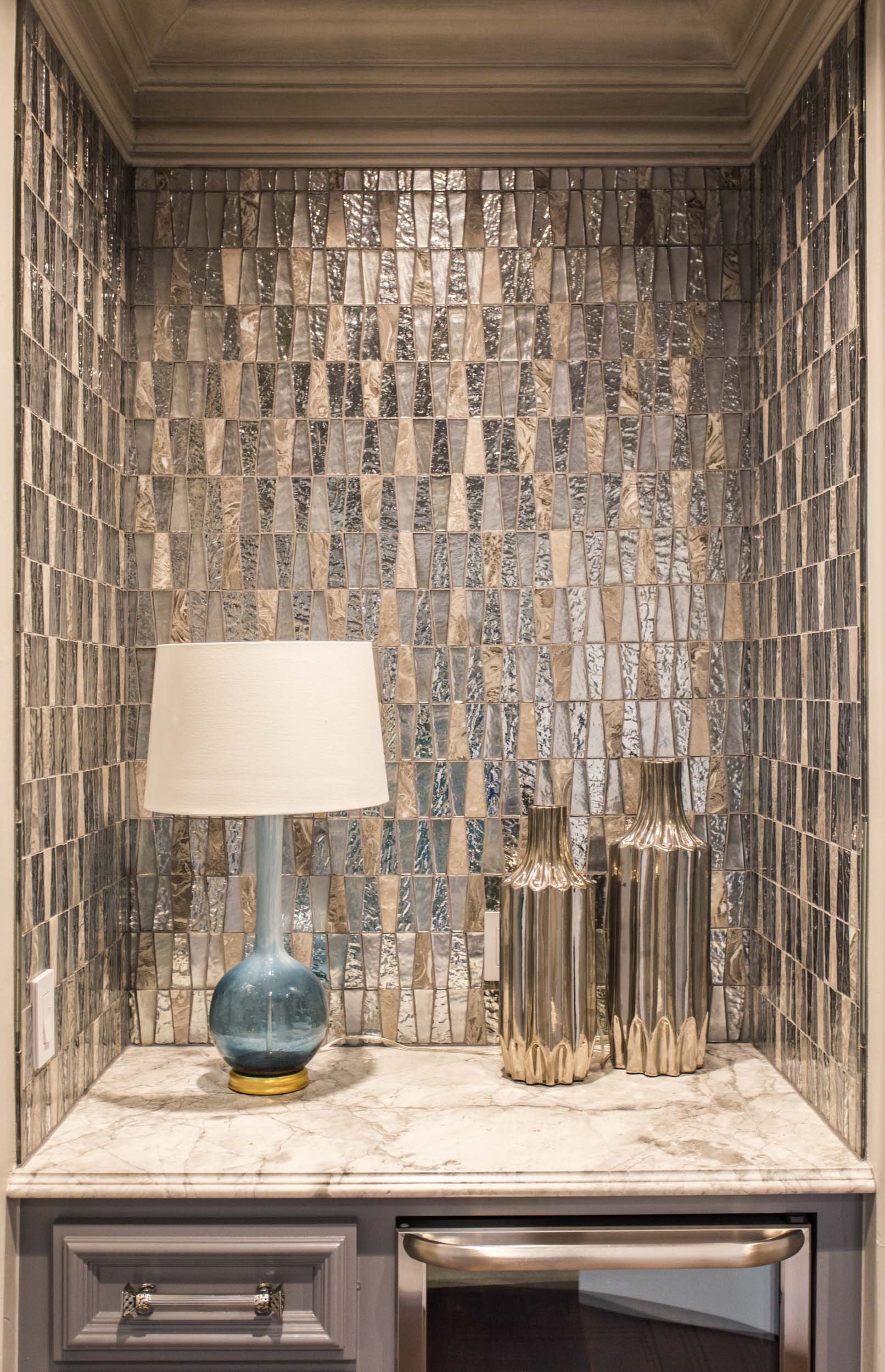  Countertop with custom tile backsplash and other decor items. 