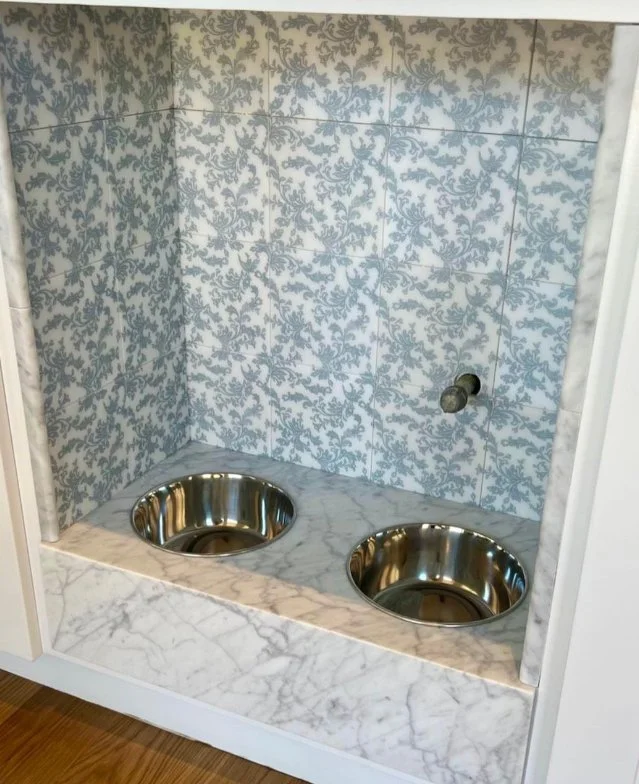  Dog food and watering area with custom tile backsplash and marble countertops. 