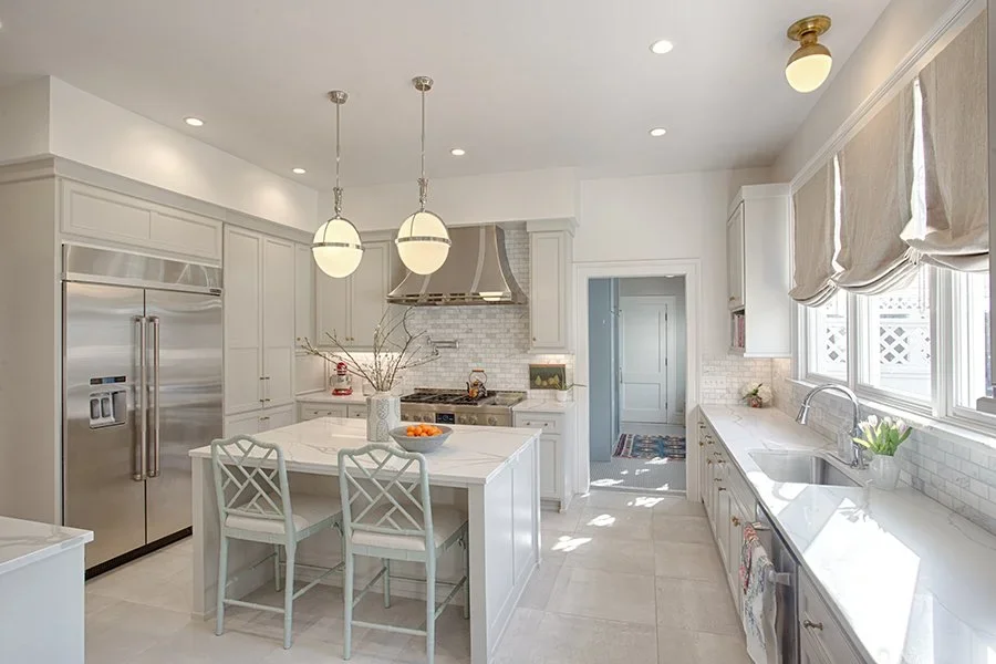  Kitchen countertops with custom tile backsplash and silver appliances.  