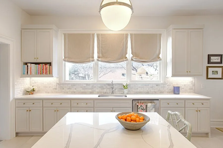  Kitchen countertops with custom tile backsplash and overhead lighting.  