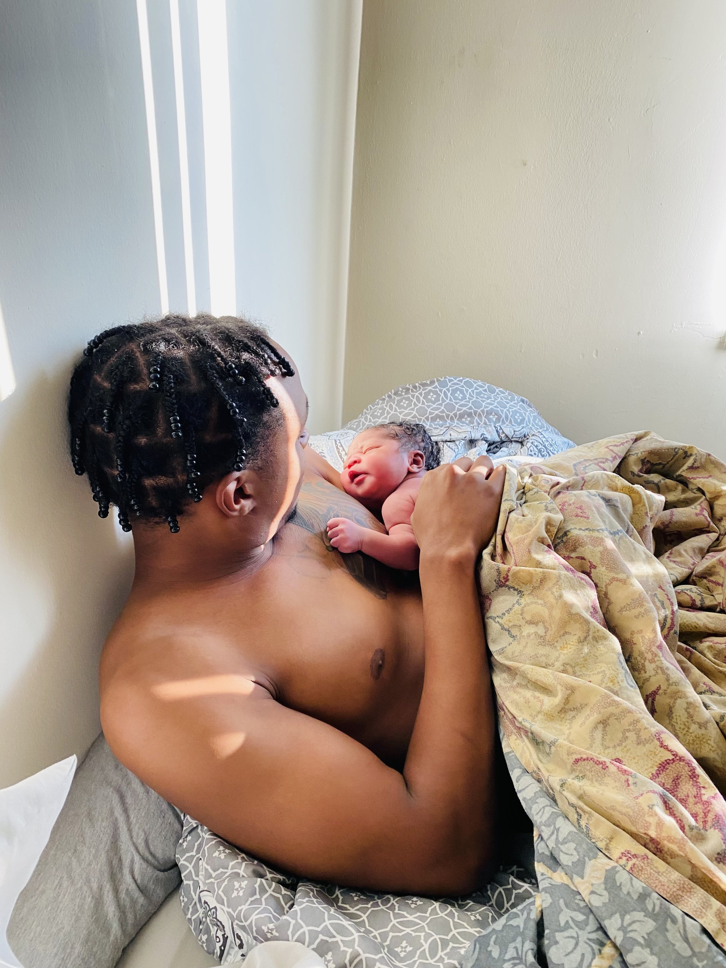 home birth dad holding newborn baby