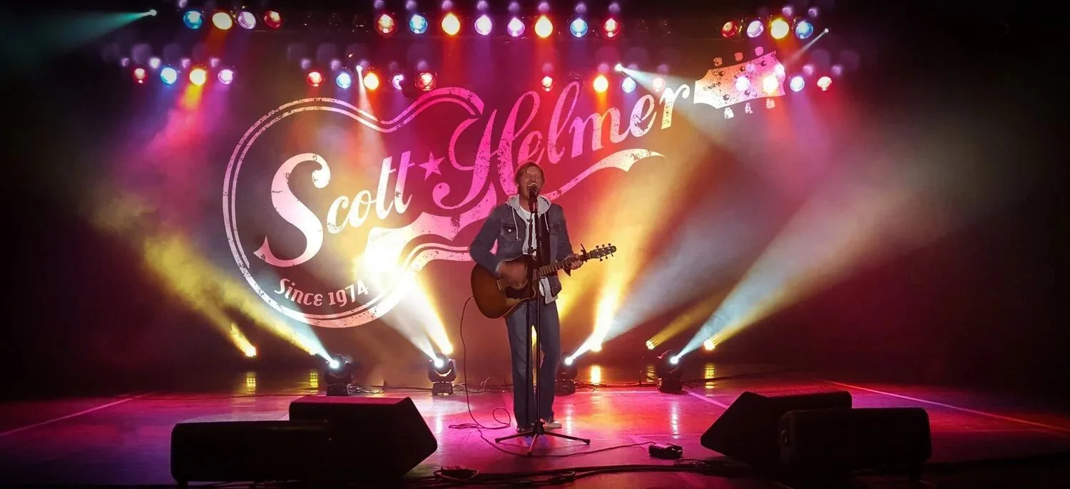 American singer-songwriter Scott Helmer performing a live solo-acoustic concert on stage.