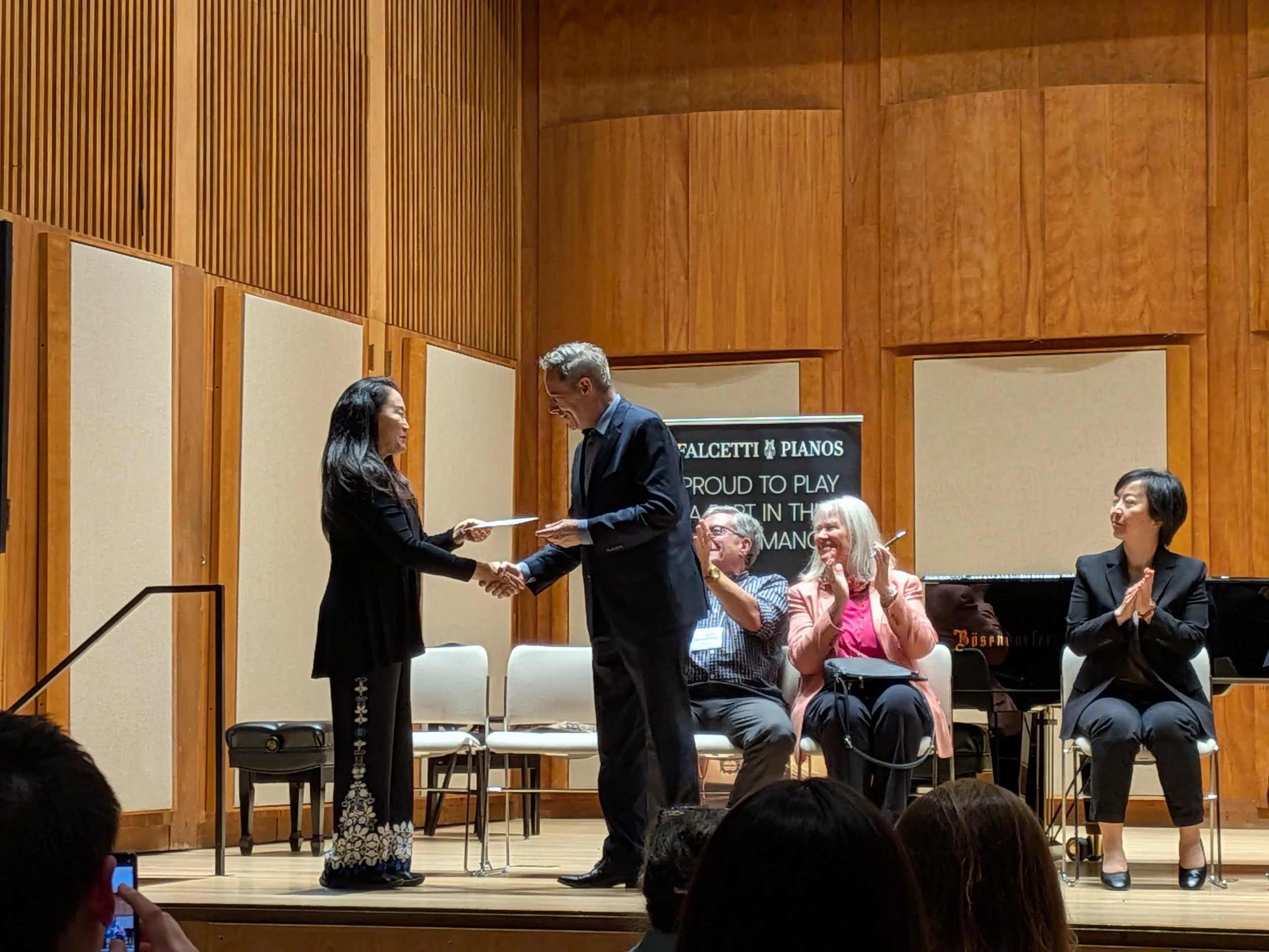 Michael Lewin congratulates Wei Ling Wang on her prize