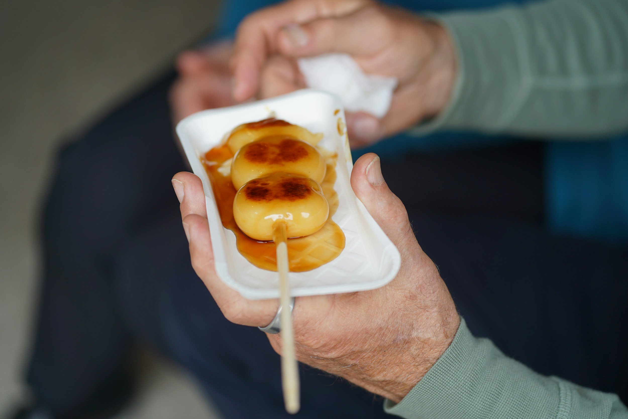 dango with sweet soy sauce on top of it