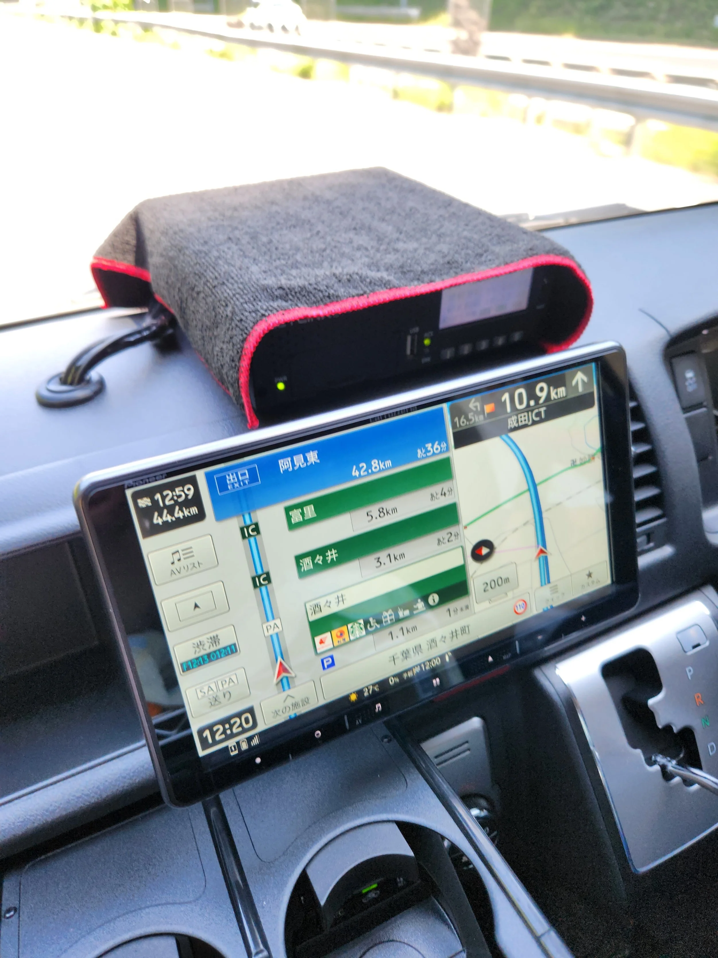 black box on top of the dashboard with a tablet that shows a map
