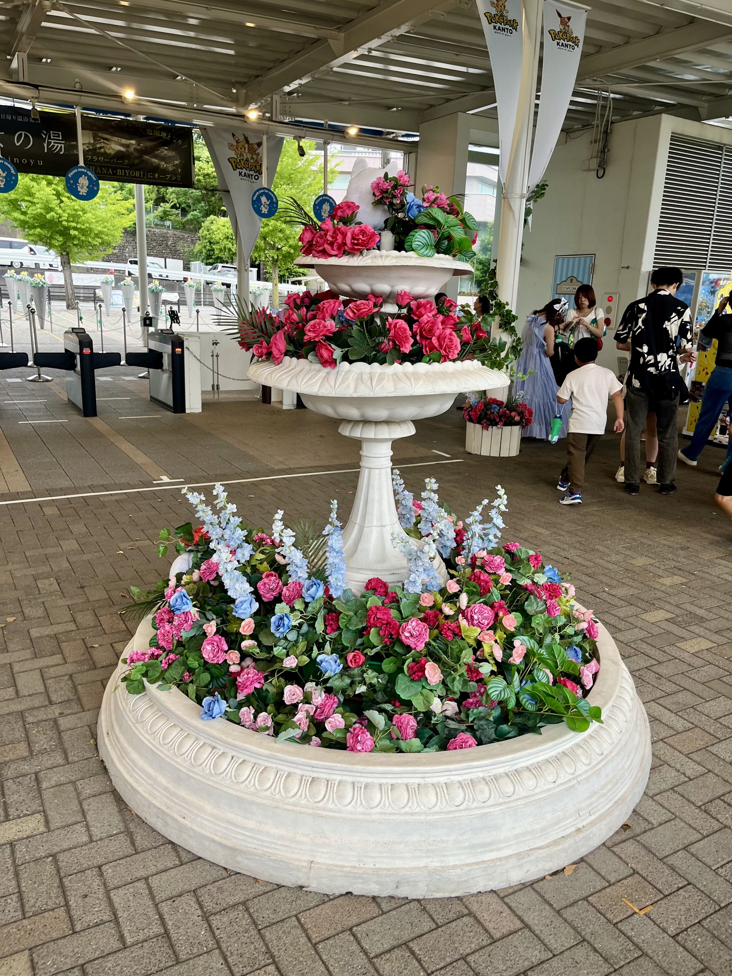 Colorful flower display at the entrance of Yomiuriland amusement park in Tokyo. Seasonal floral decorations welcome visitors as they arrive at the park.