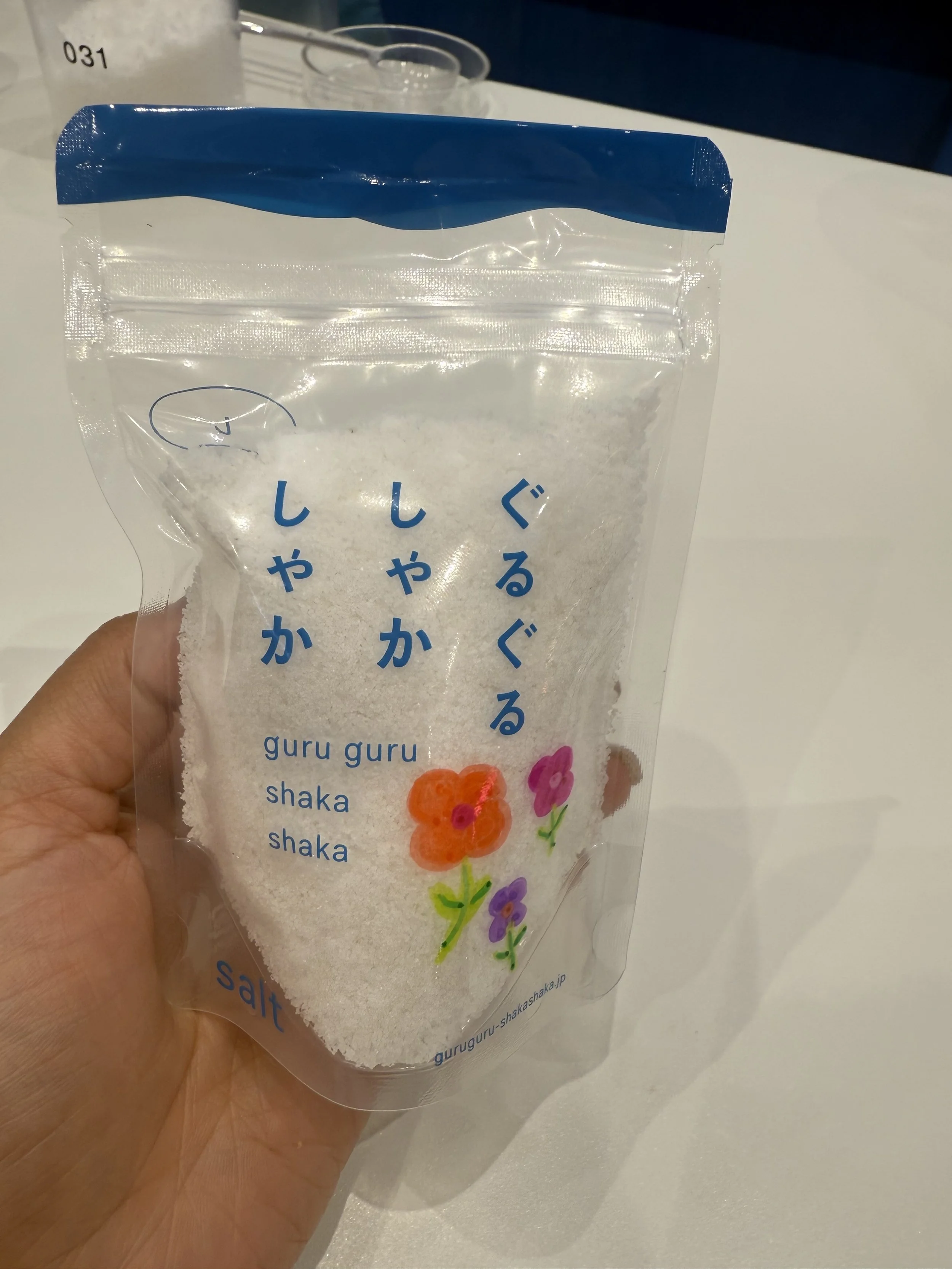 Packaged custom salt blend created during the Guruguru Shakashaka salt making experience in Tokyo. The personalized seasoning is sealed in a souvenir pouch for visitors to take home and use in their own cooking.