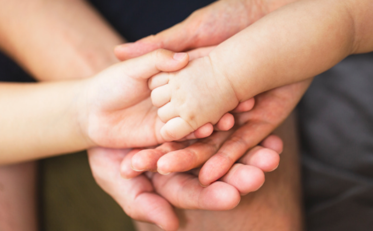 Multigenerational family holding hands