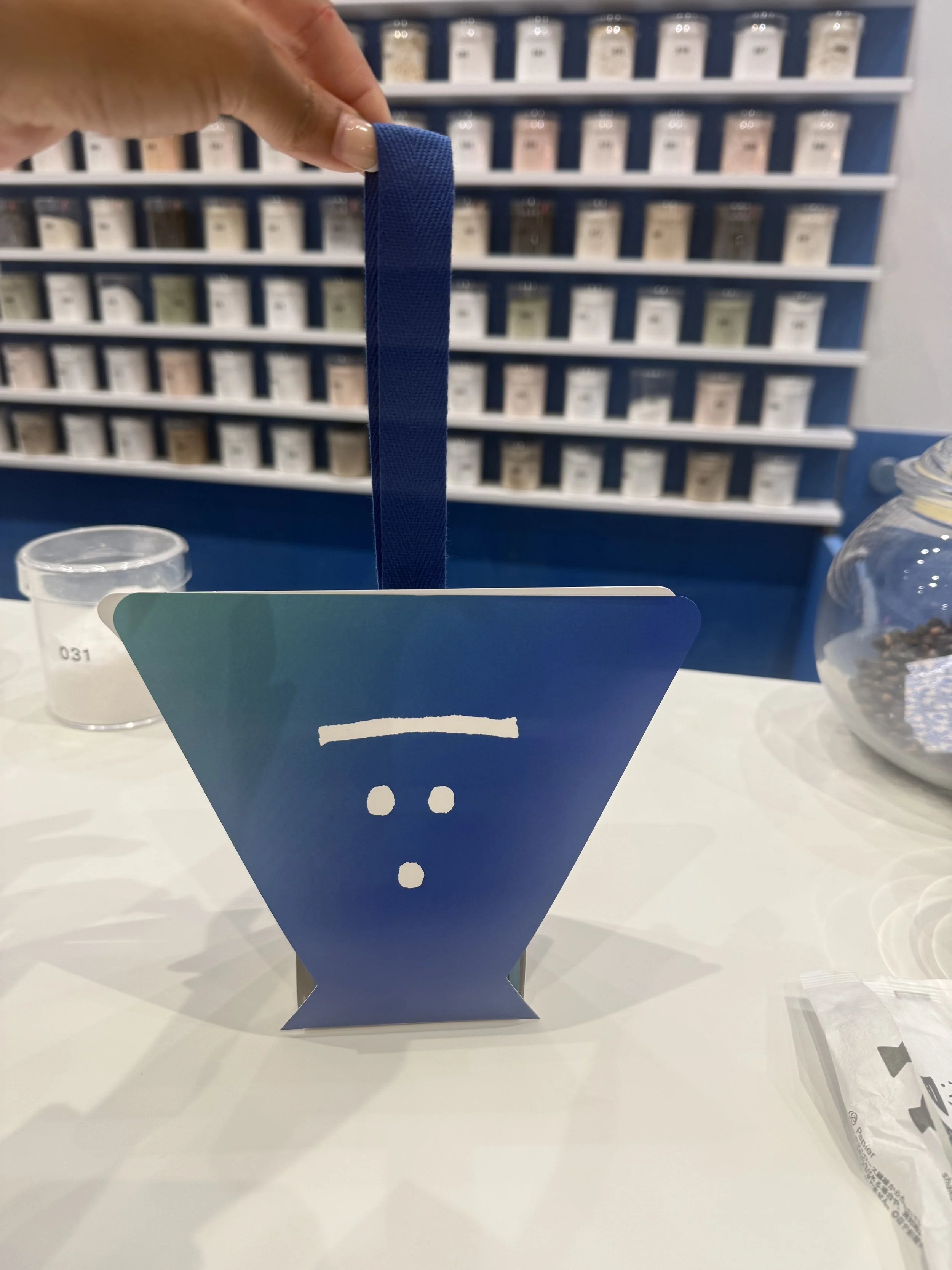 Blue container used to package a personalized salt blend during the Guruguru Shakashaka salt making experience in Tokyo. Each custom salt blend is prepared and packaged for visitors to take home as a souvenir.