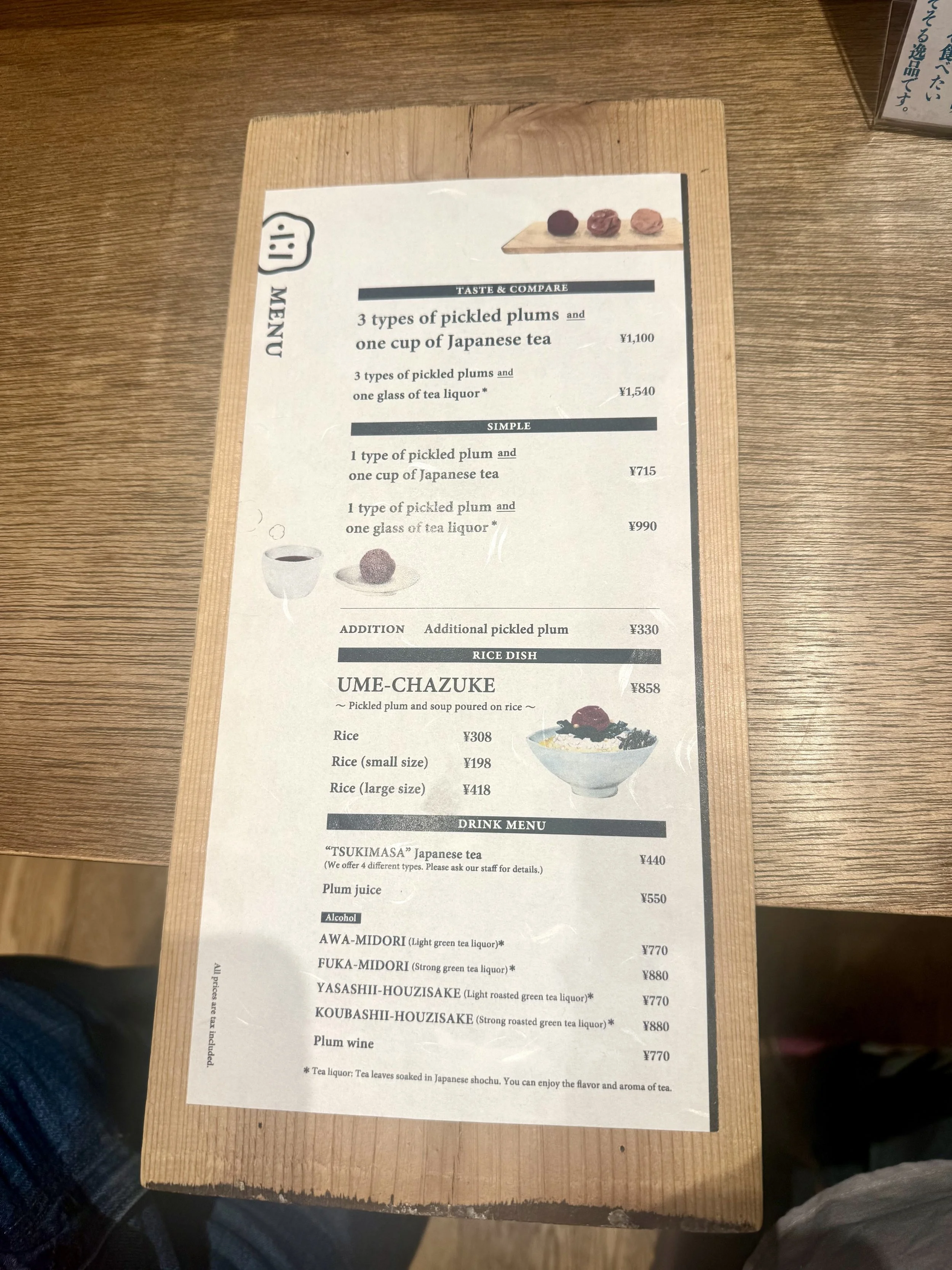 Menu at Tachigui Umeboshi-ya in Tokyo featuring umeboshi tasting sets, Japanese tea pairings, rice dishes, and specialty drinks. Visitors can choose different ways to experience Japanese pickled plums.