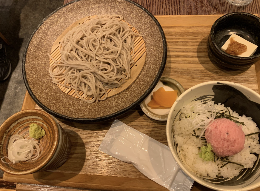 A set meal of cold soba, wasabi and onions, Japanese pickles, and a rice bowl are pictured.