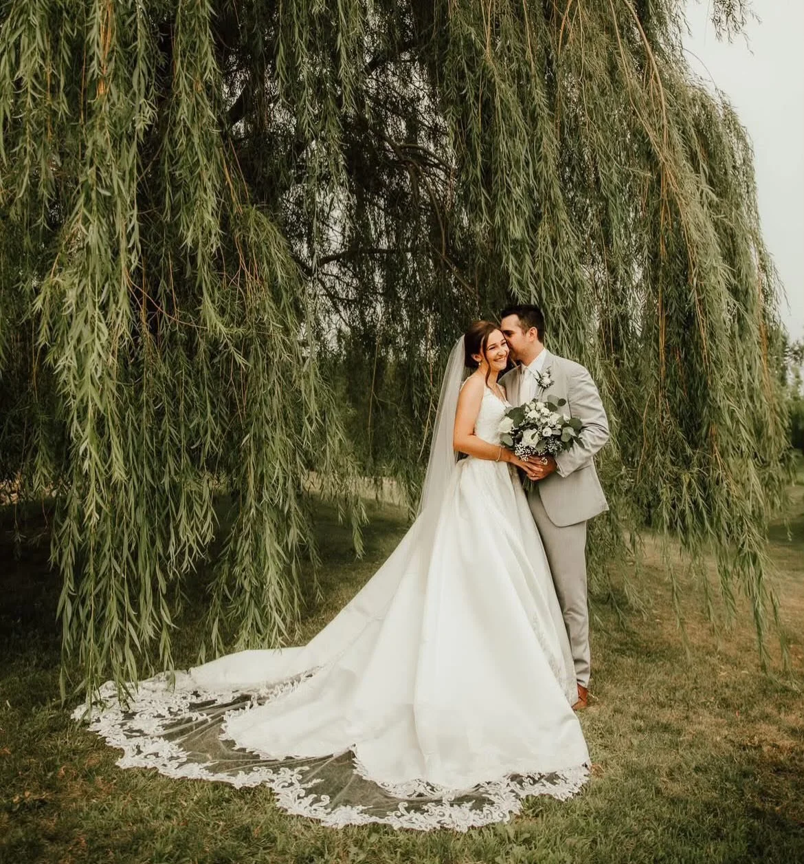 The willow trees made for such a perfectly romantic backdrop for Cheyenne&rsquo;s wedding photos! Cheyenne looked stunning in her classic satin ballgown by @moonlightbridal ✨ Wishing you two all the best &amp; thankful to you for sharing your photos 