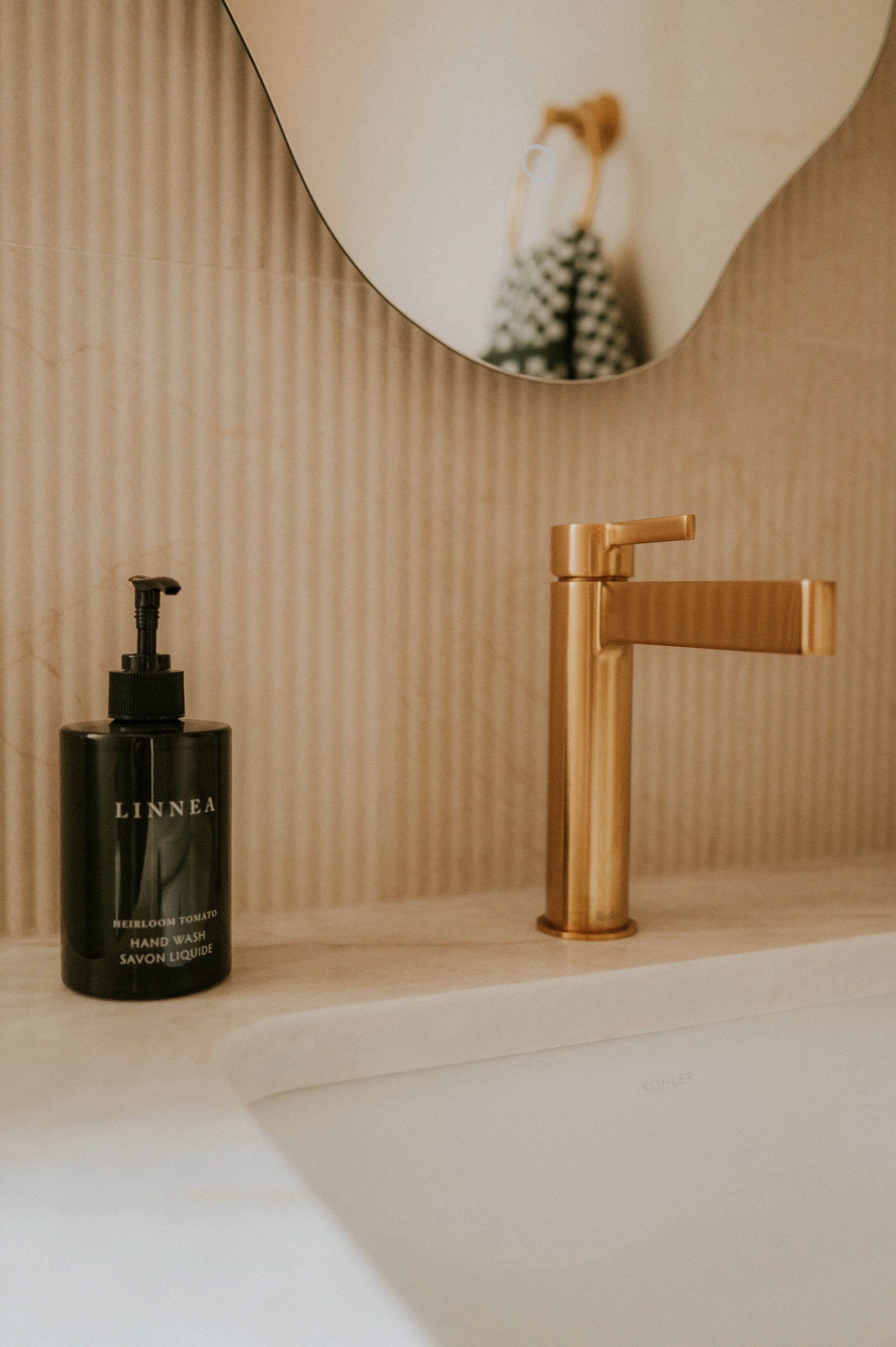 Gold Sink and Textured Tile Backsplash