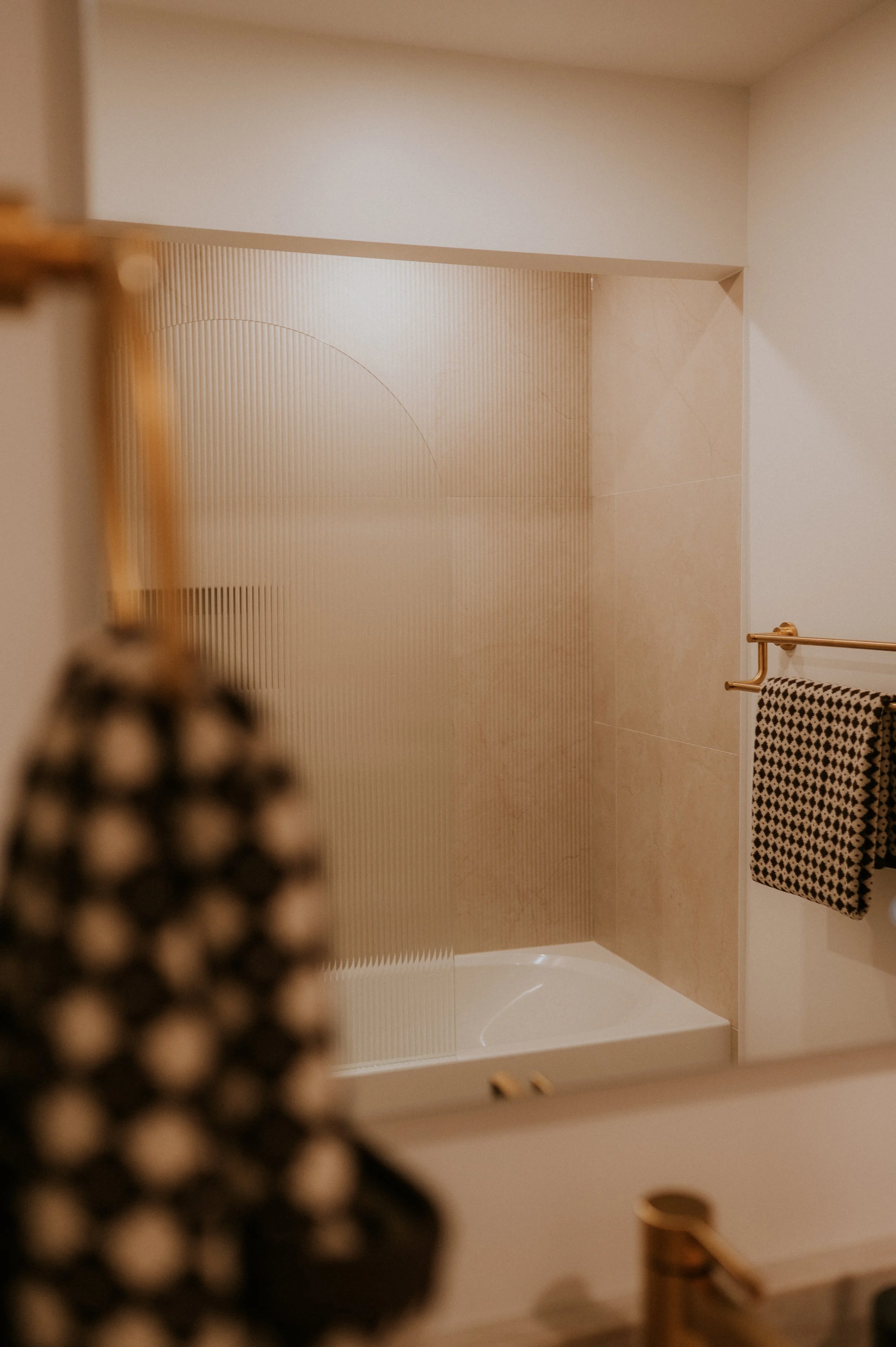 Fluted Arched Shower Glass and Gold Hardware