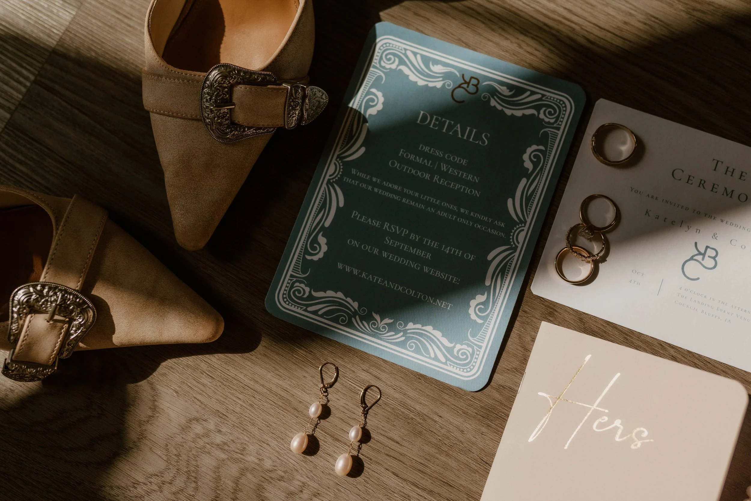 Wedding details captured in Council Bluffs at The Landing Event Venue. Rings, invitation suite, and bridal accessories.