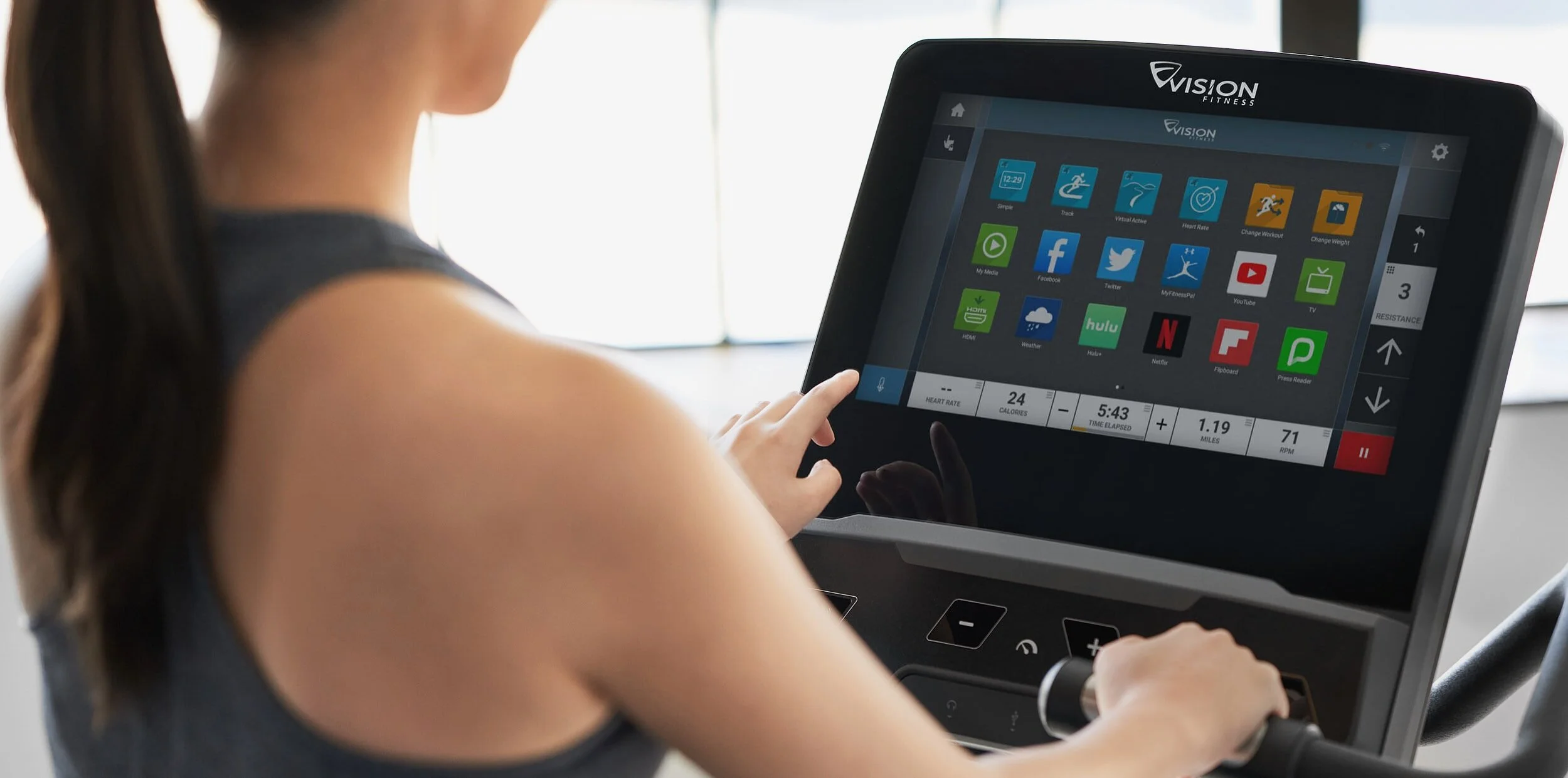 Close-up of a woman using a fitness treadmill control panel with American English navigation options, app icons, and workout statistics.