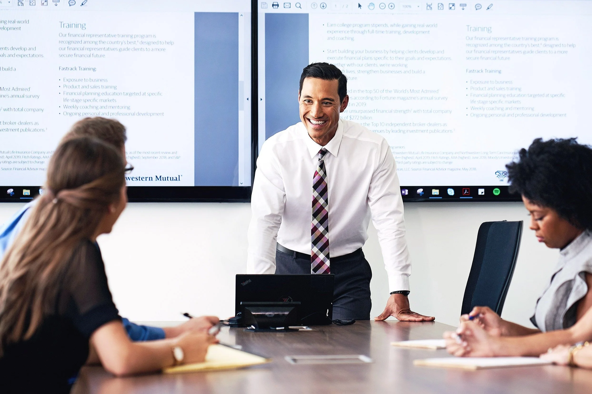 Corporate leadership photography of executive presenting strategy to financial services team in boardroom meeting.