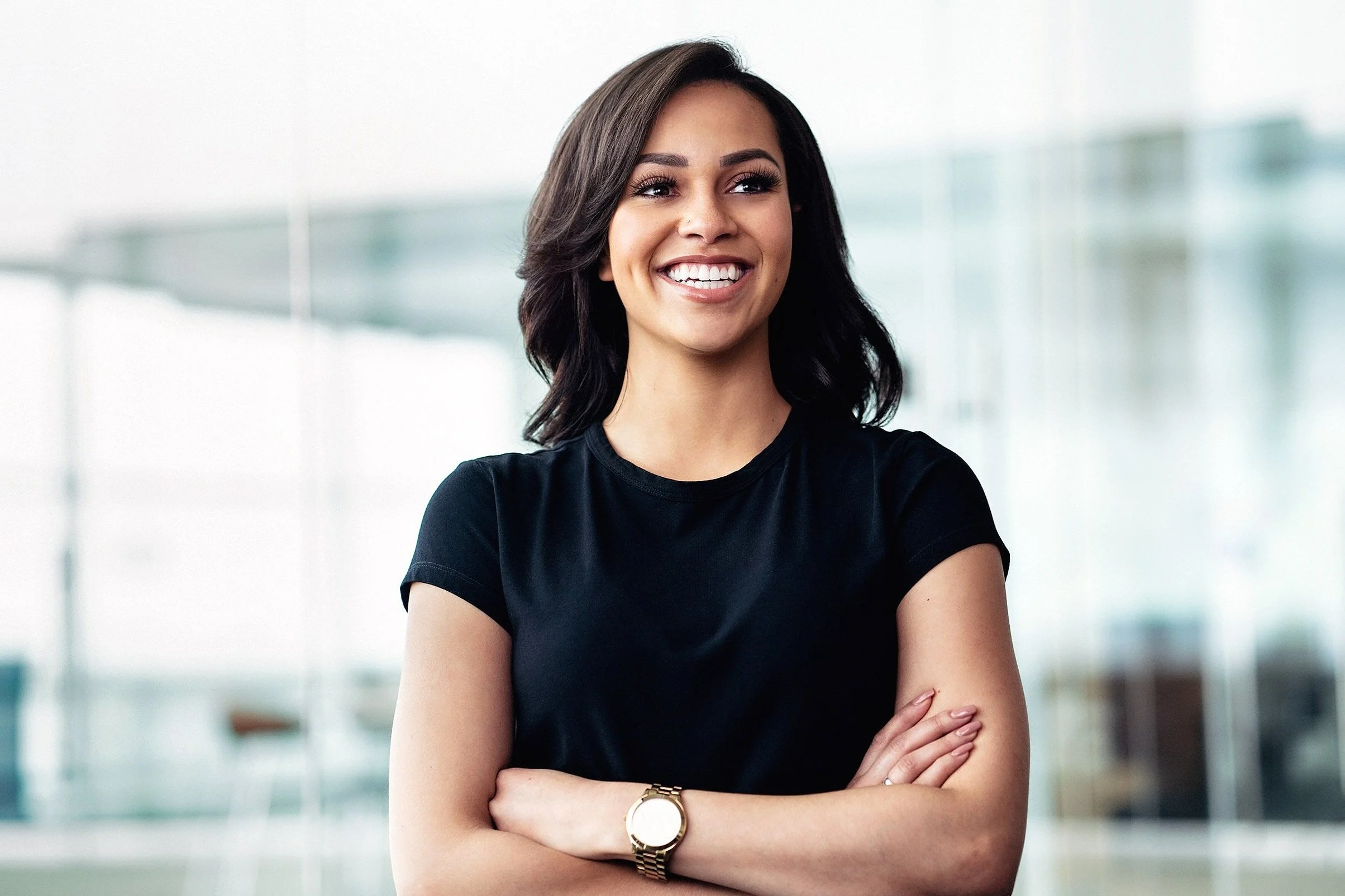 Corporate recruitment photography featuring confident young professional in modern financial services office.
