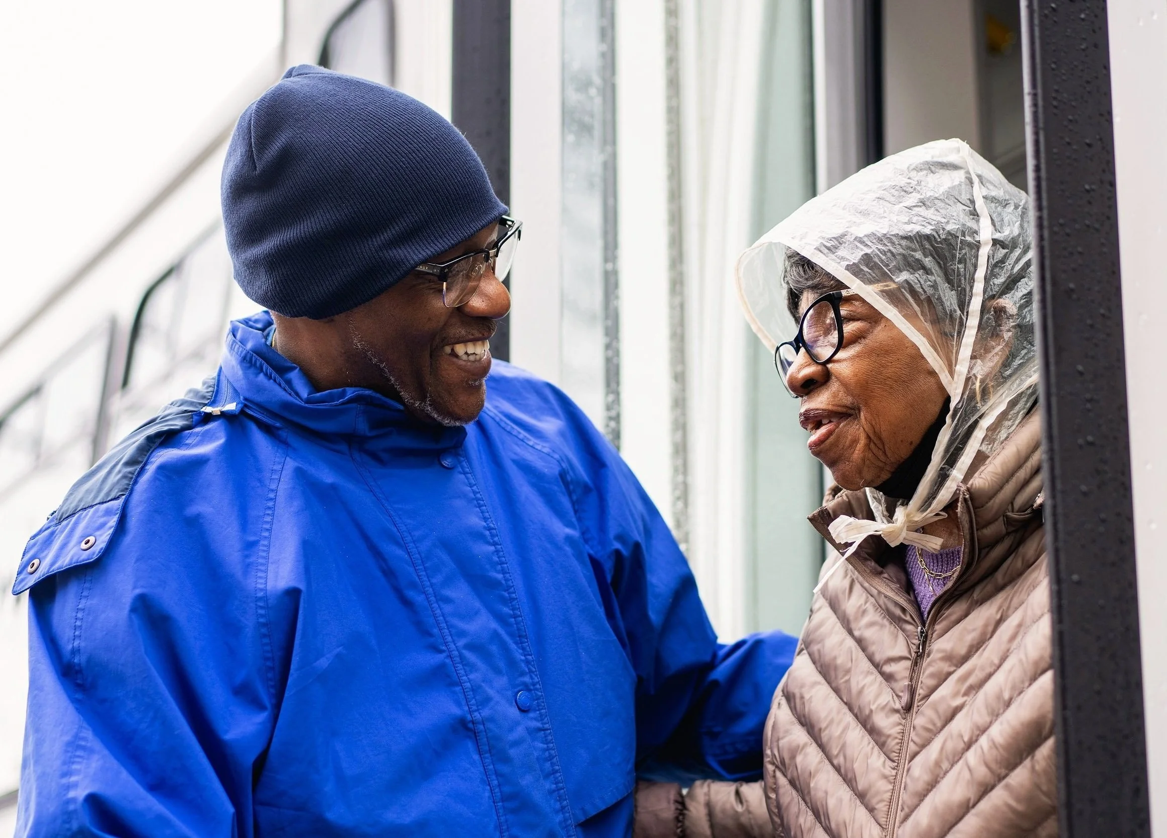 Community outreach worker speaking with a senior woman during a Chicago Commons home visit.