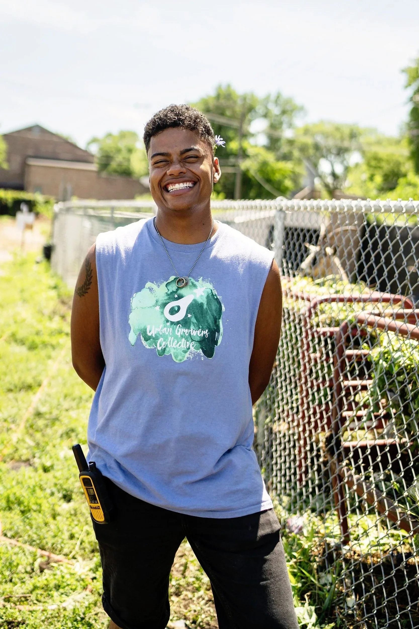 Environmental portrait of an Urban Growers Collective member in a Chicago community garden, highlighting local food and community agriculture.