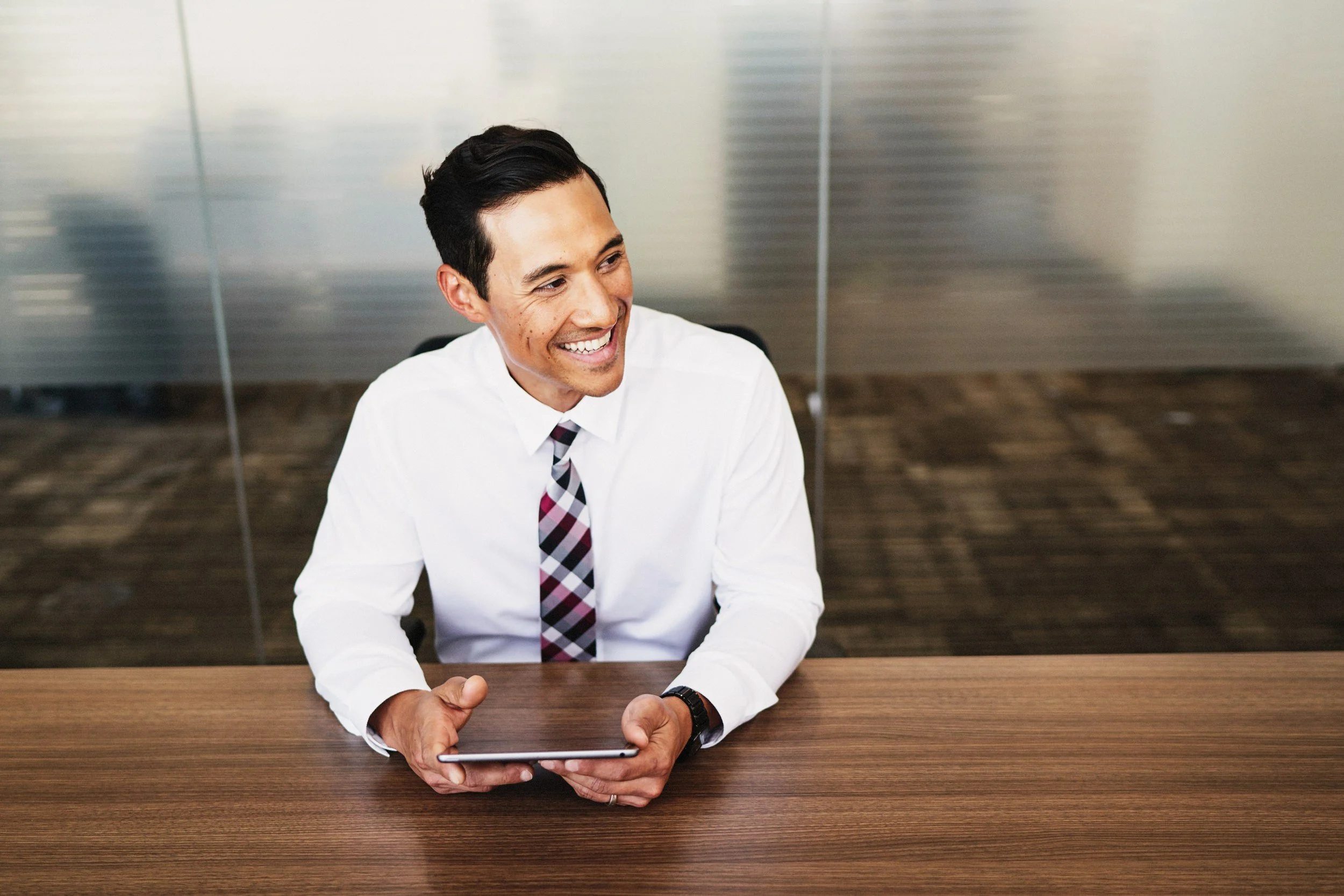 Hospital executive reviewing digital healthcare systems in a modern office environment, highlighting leadership and strategic oversight.