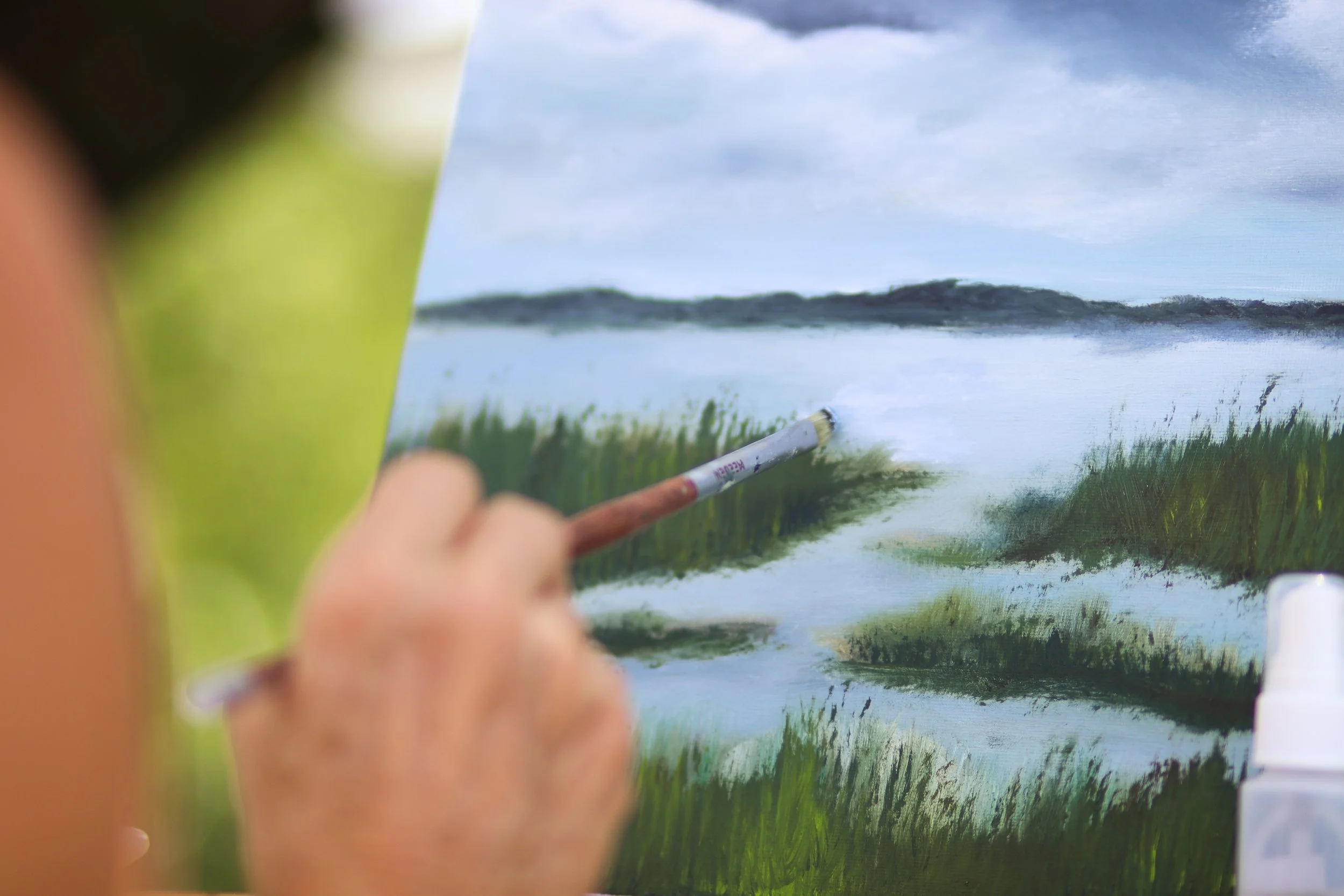 Artist Diana Paxton painting a river scene